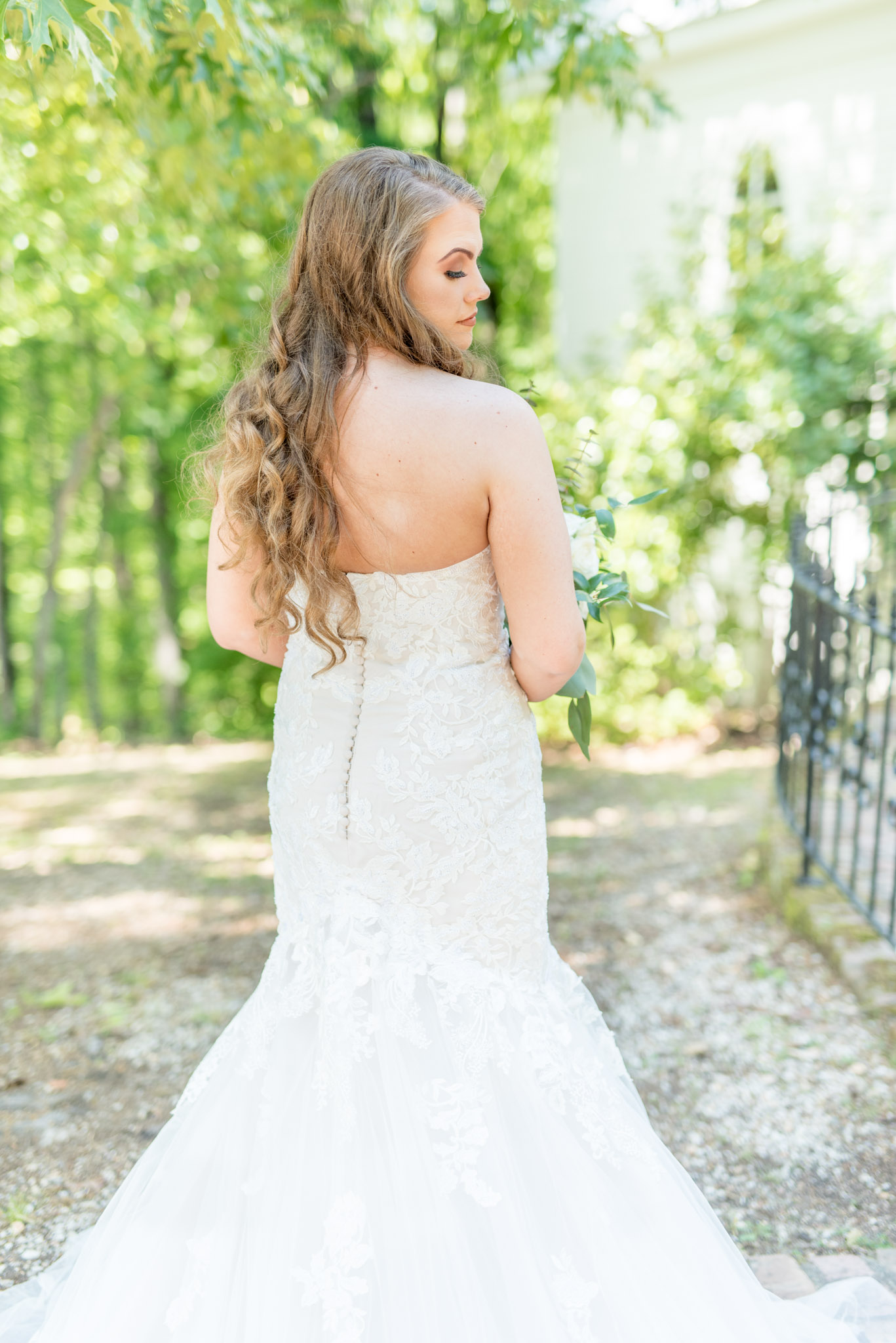 Bride looks over her shoulder.