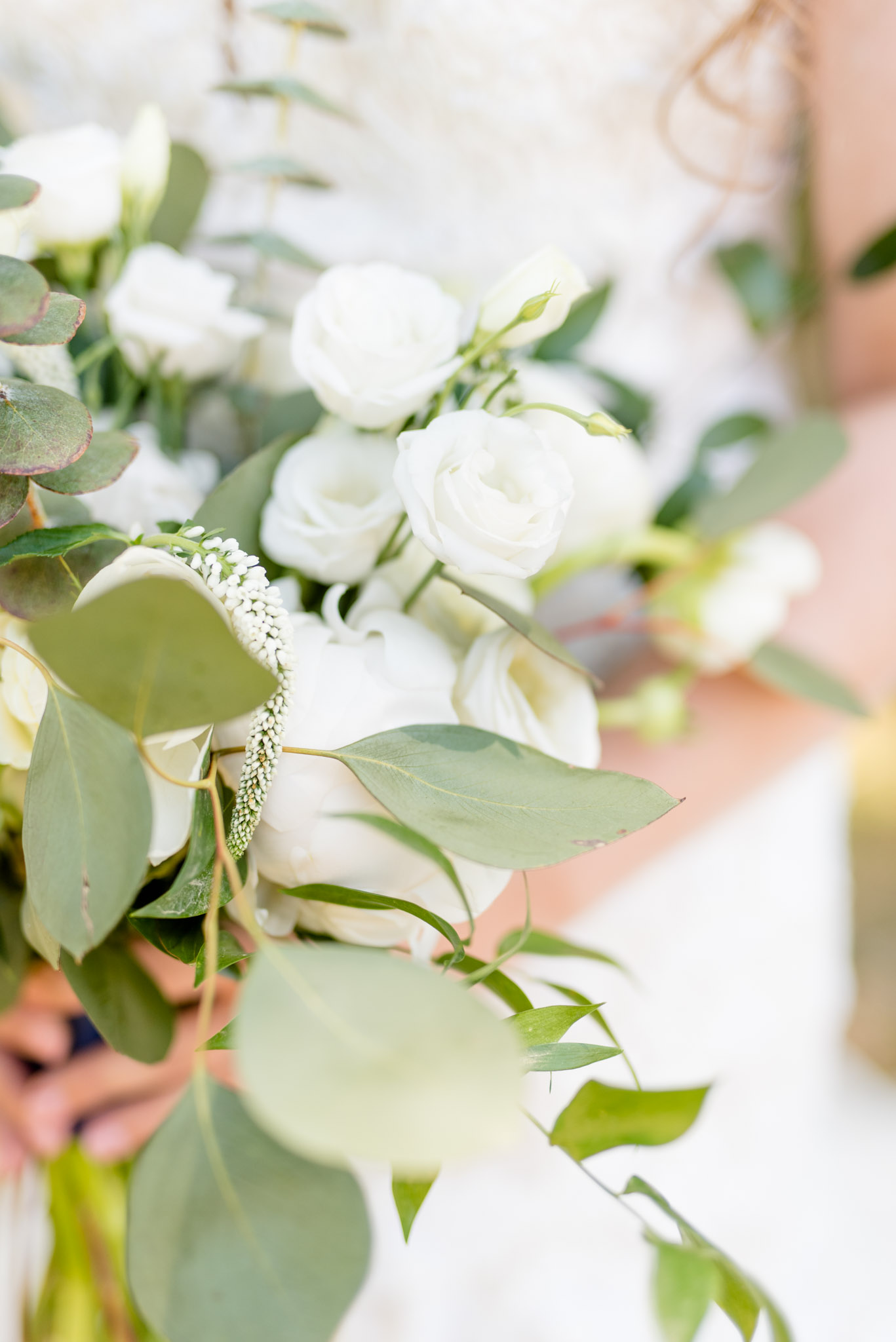 White flowers on bride's bouquet.