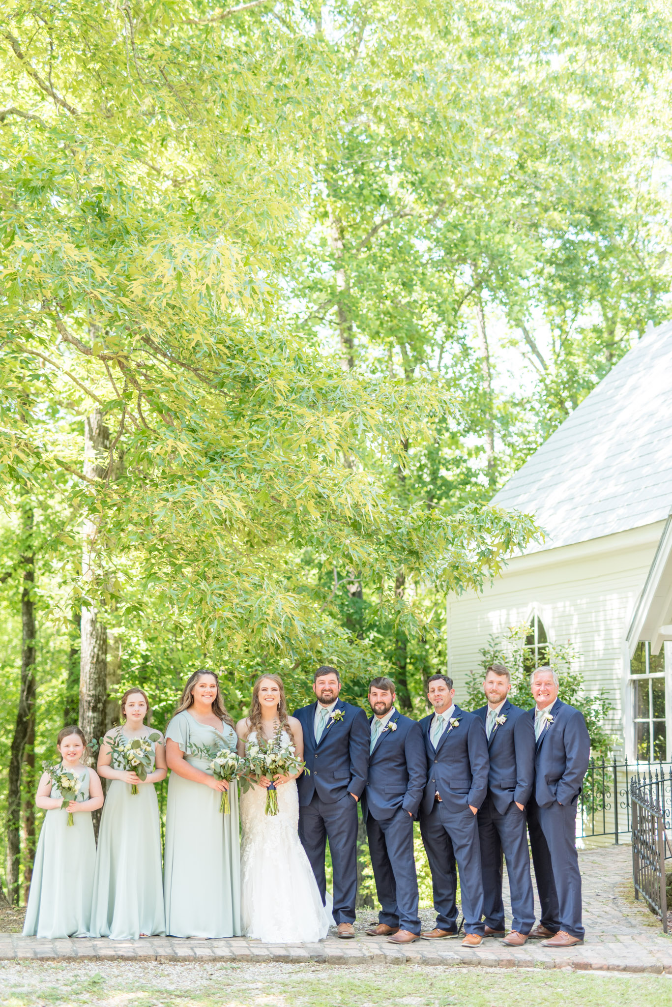 Bridal party smiles at camera.