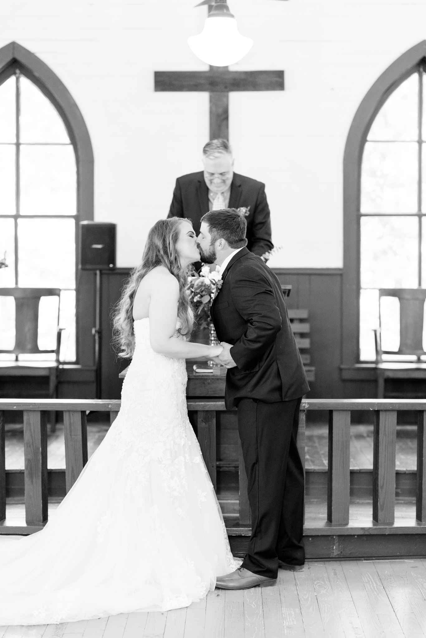 Bride and groom kiss during ceremony.