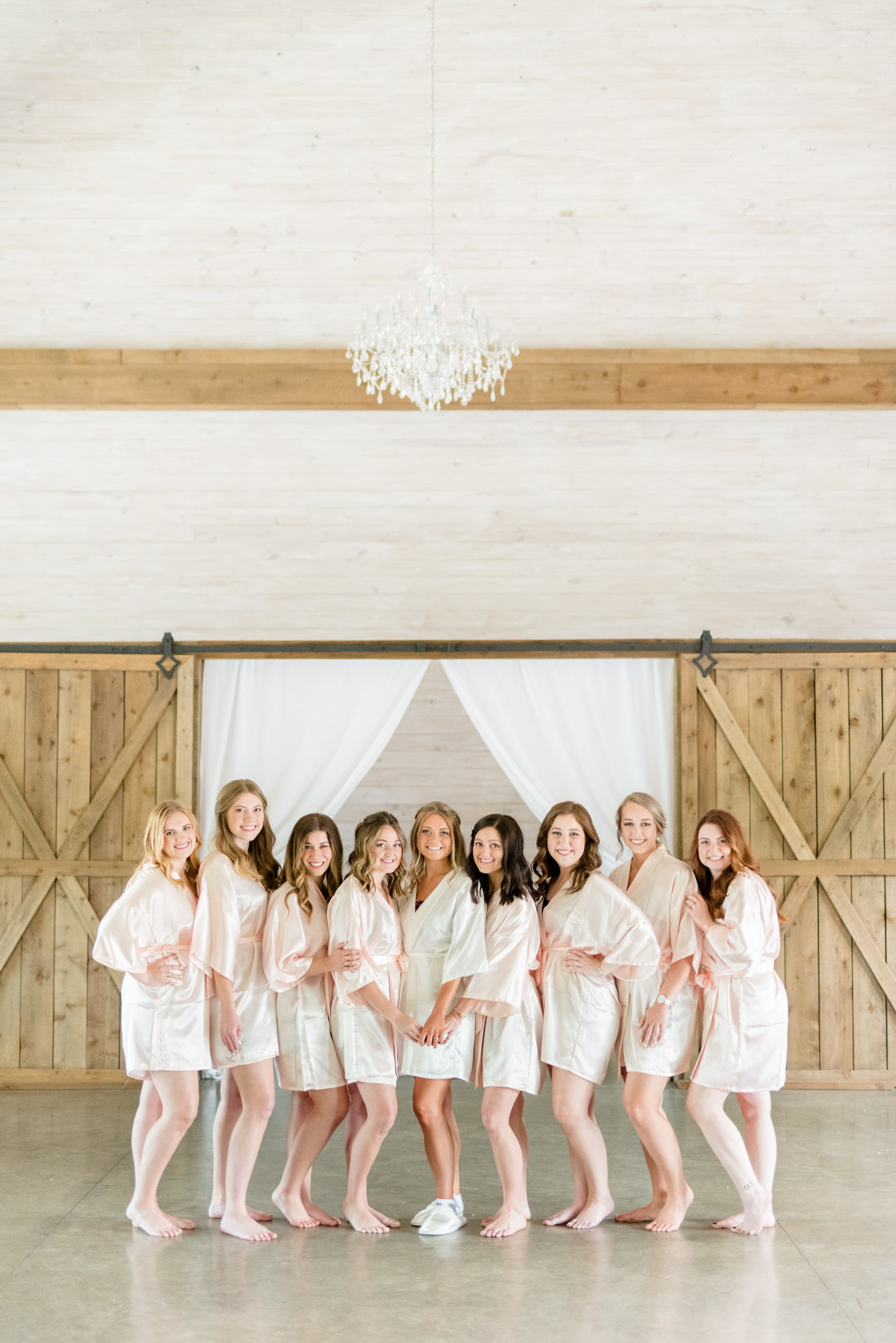 Bridal party poses in cute robes.