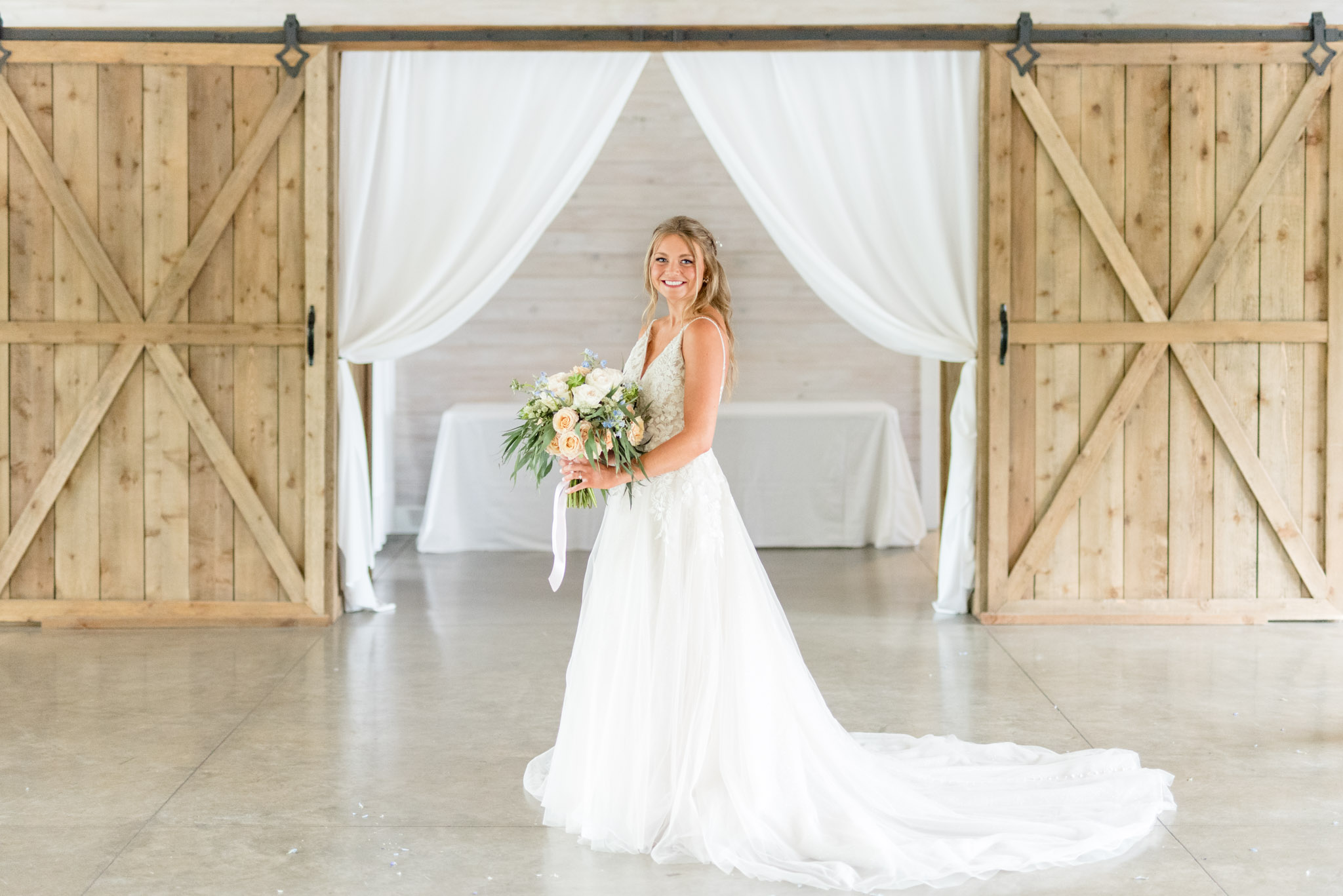 Bride poses and smiles.