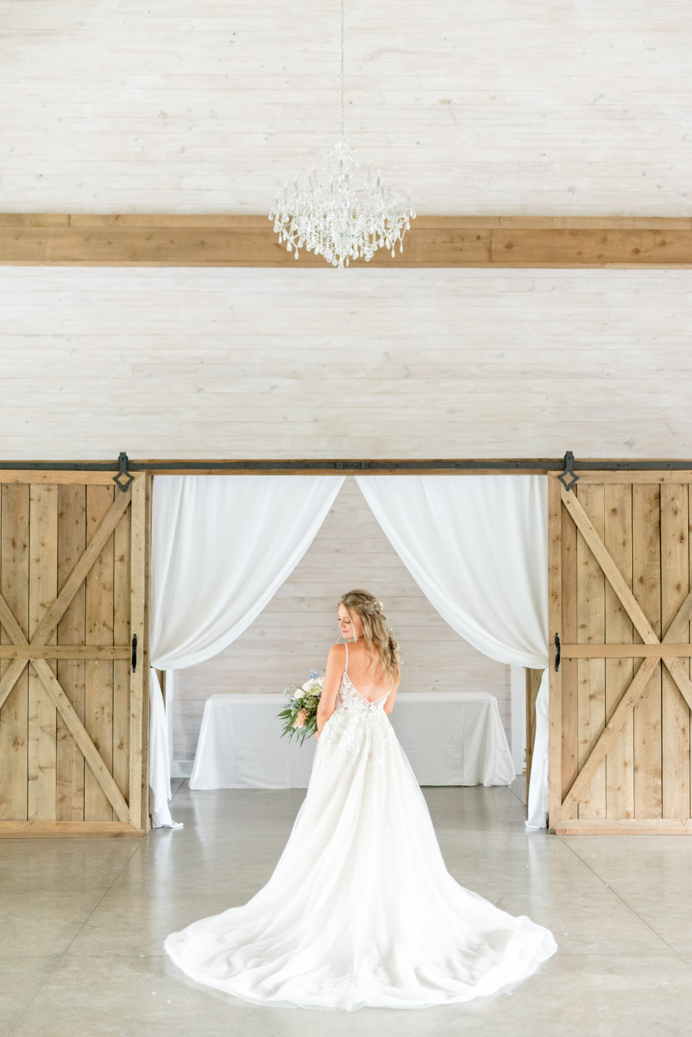 Bride shows off train of dress.