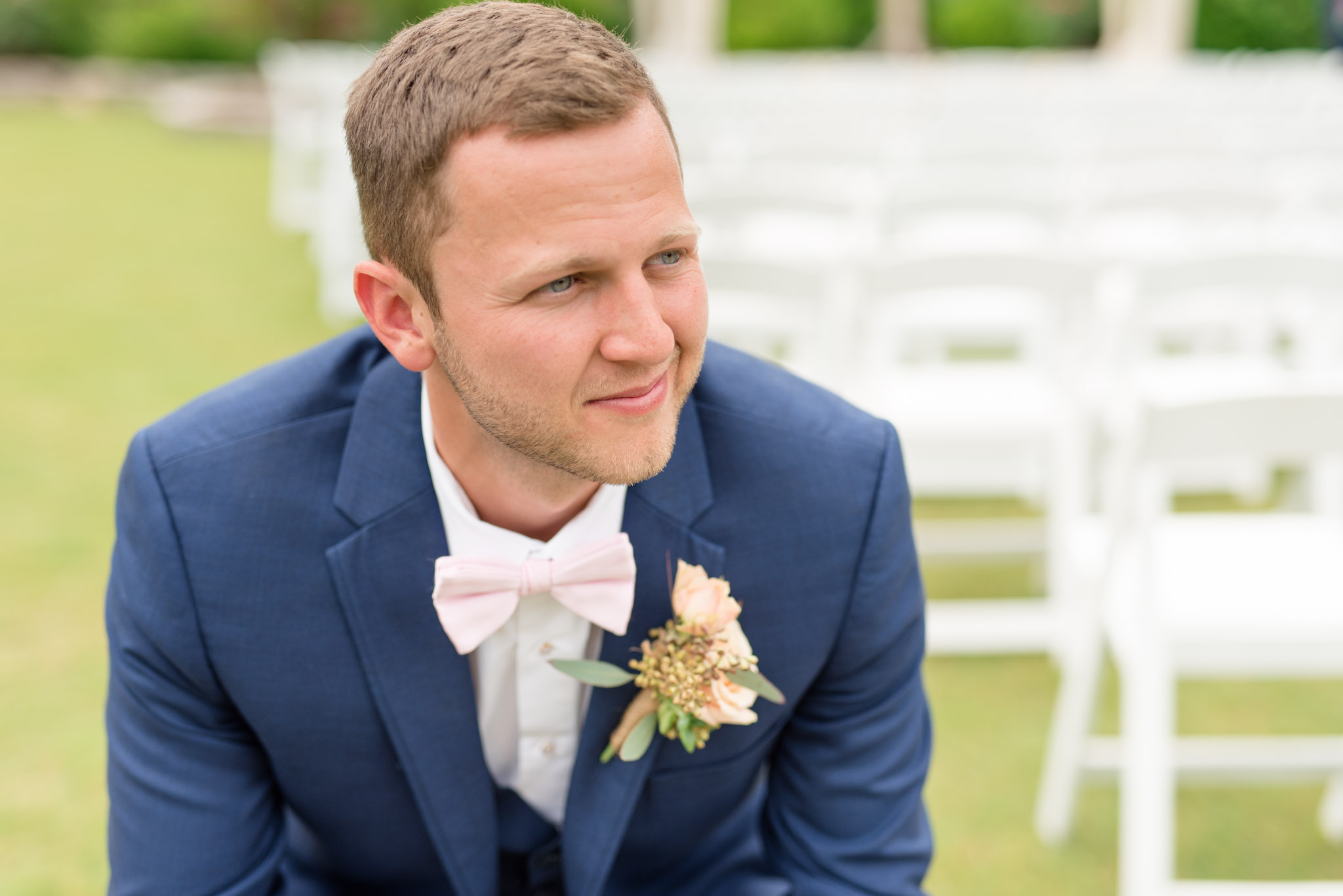 Groom looks over shoulder.