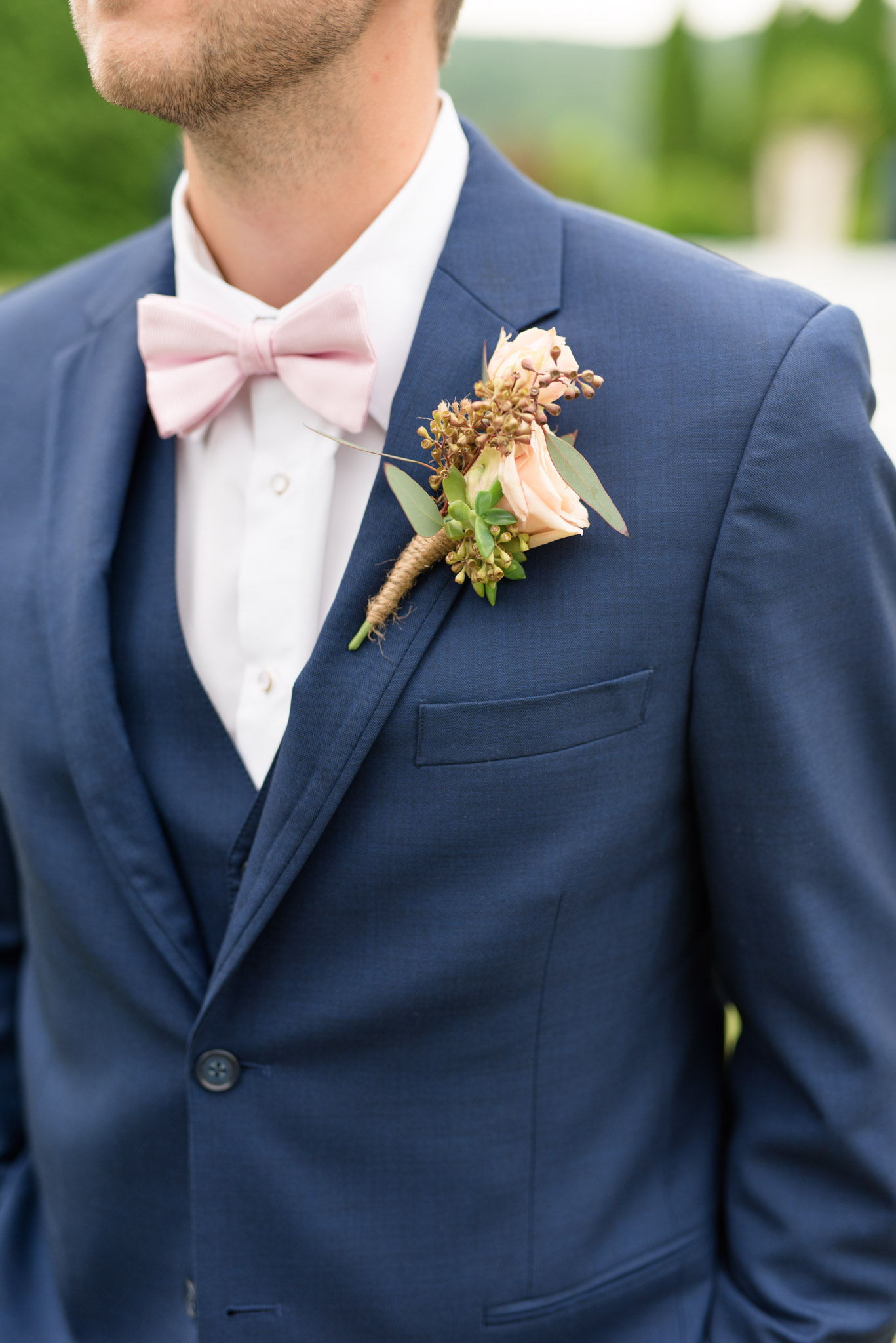 Groom's boutonniere pinned on jacket.