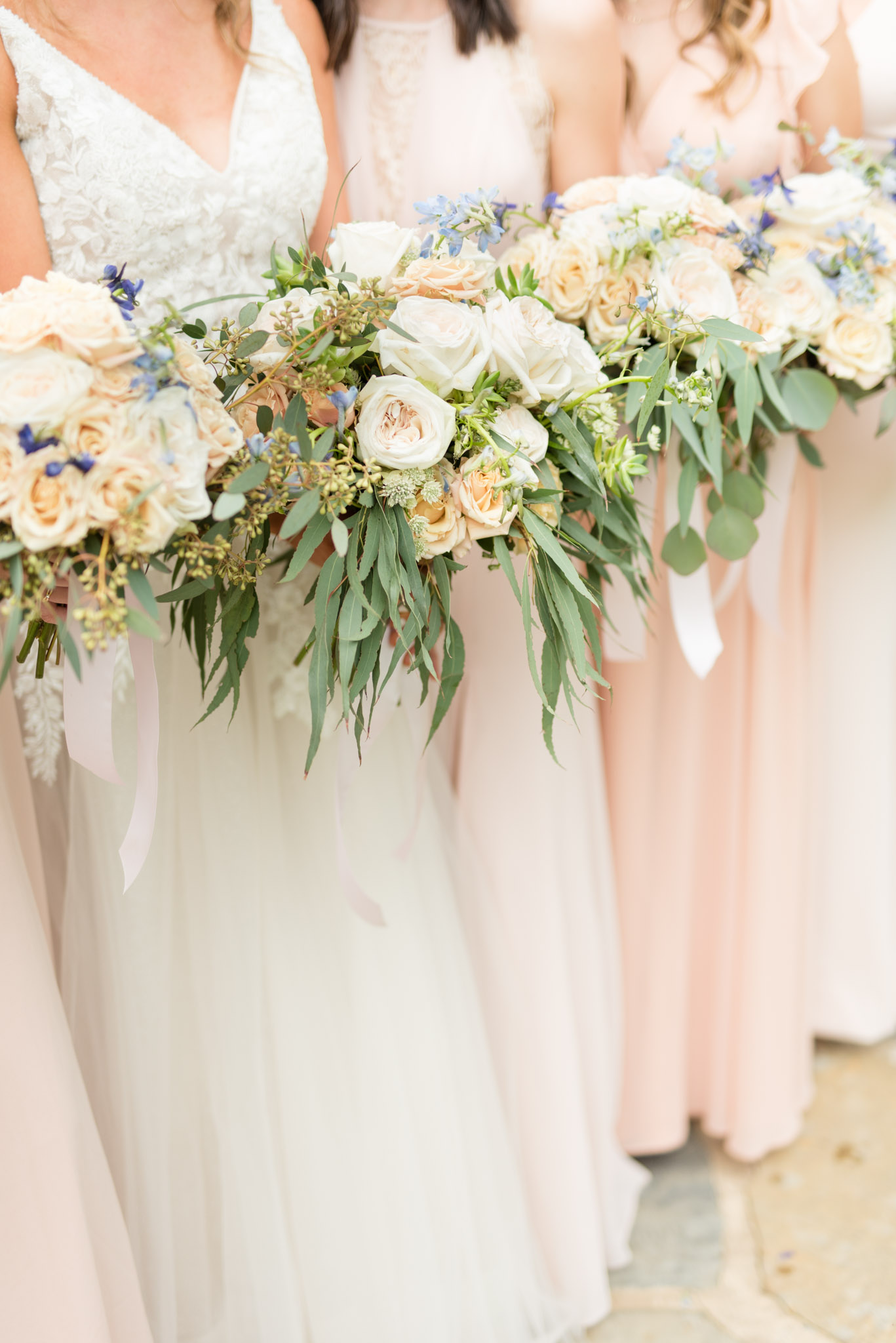 Bridal party holds bouquets.