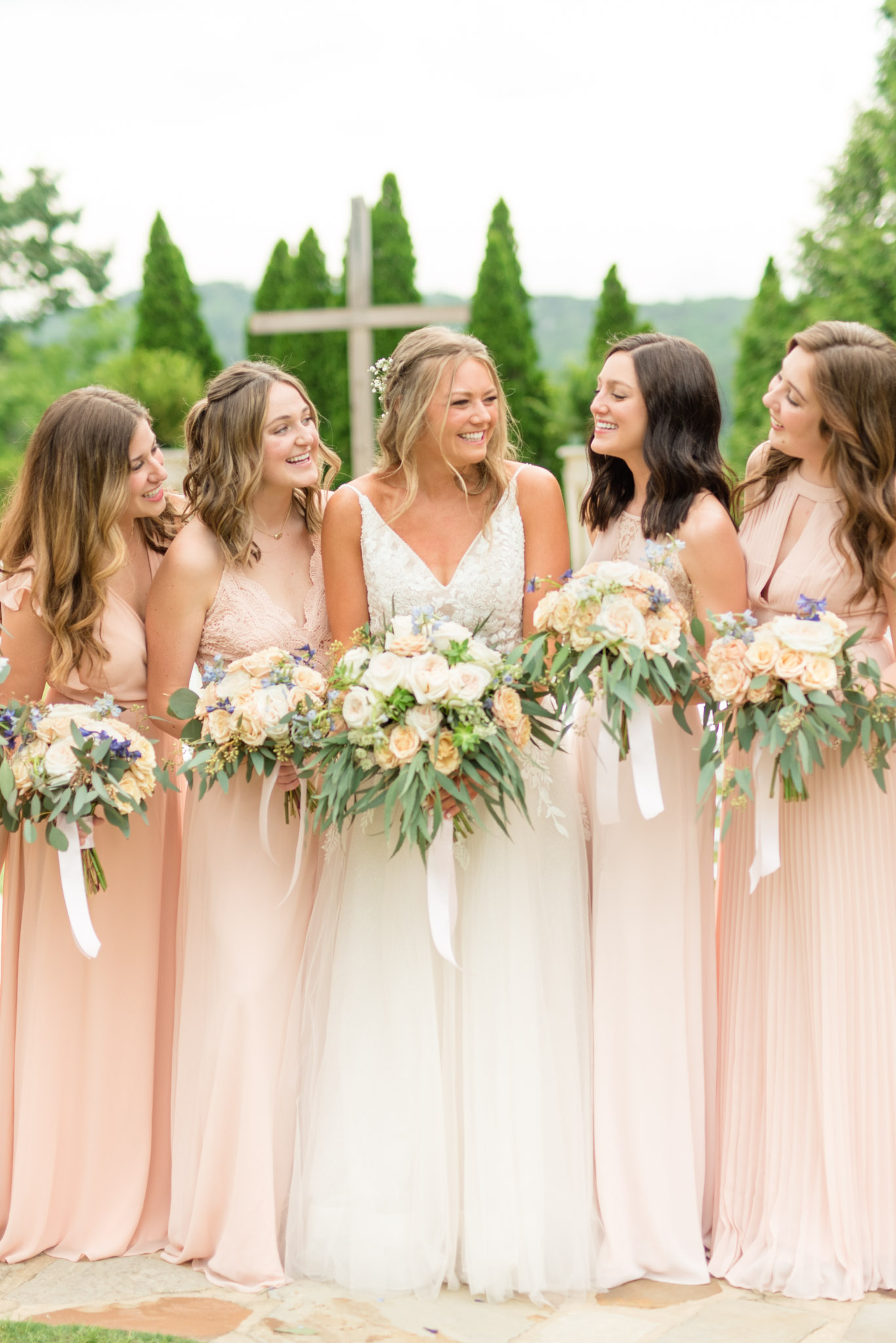 Bride and her bridesmaids laugh at Park Crest Event Facility.