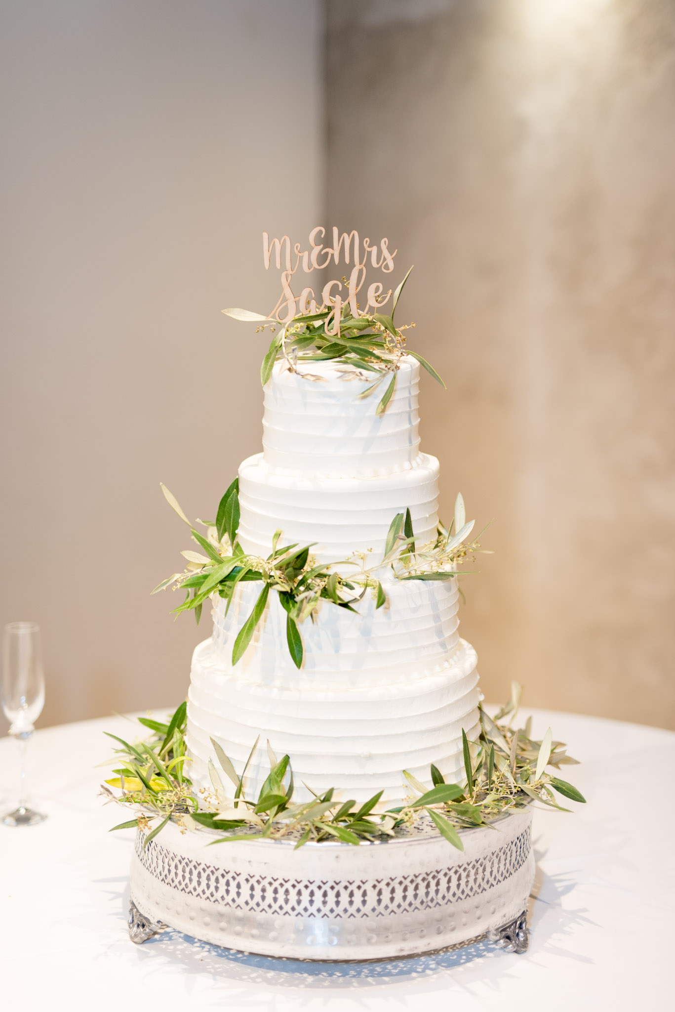 White wedding cake sits on table.