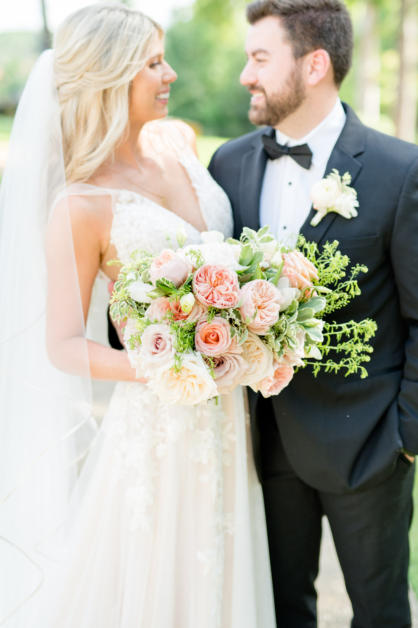 Closeup of bridal bouquet and bride and groom.