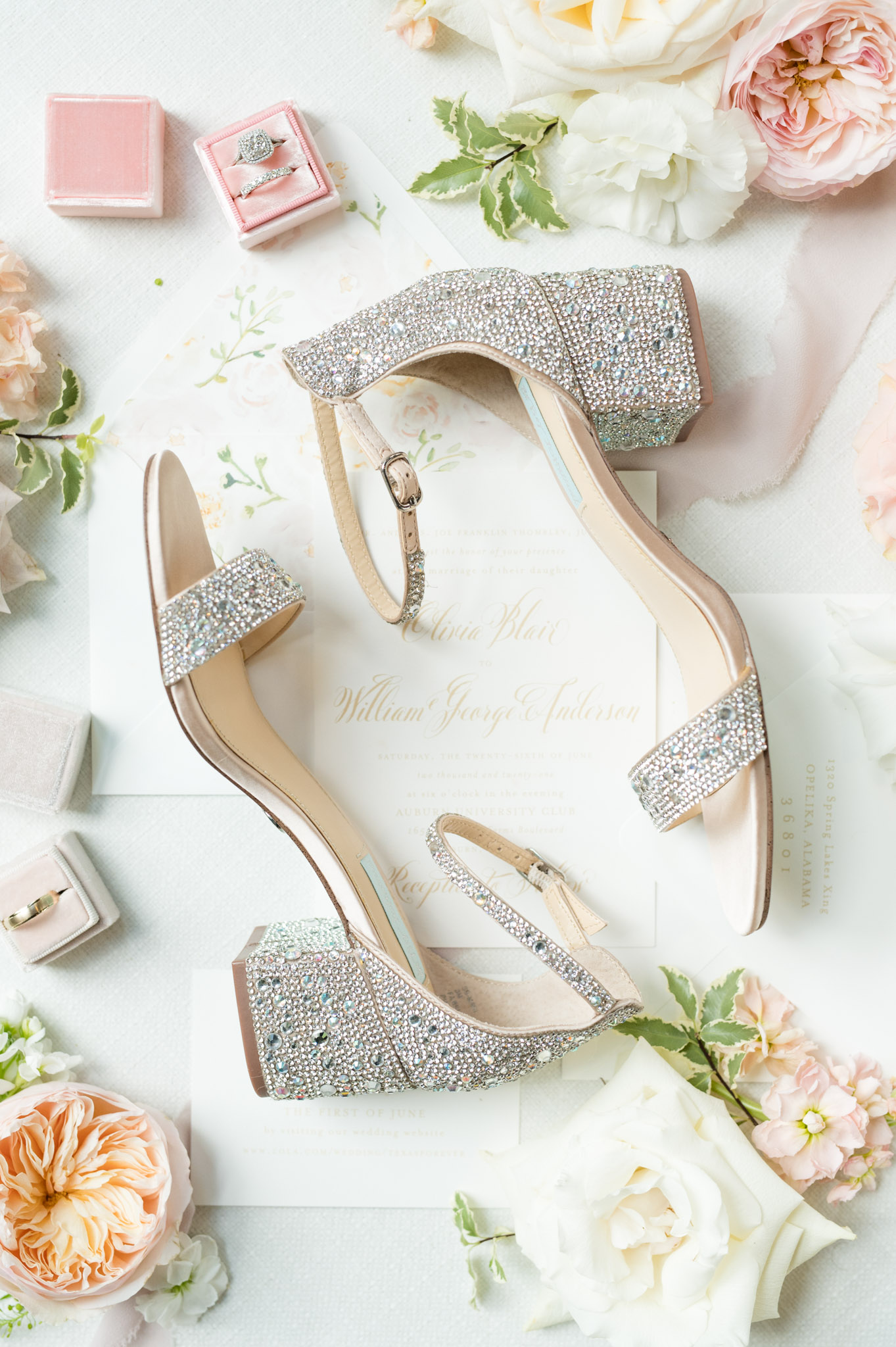 Bridal shoes sit with flowers and details.