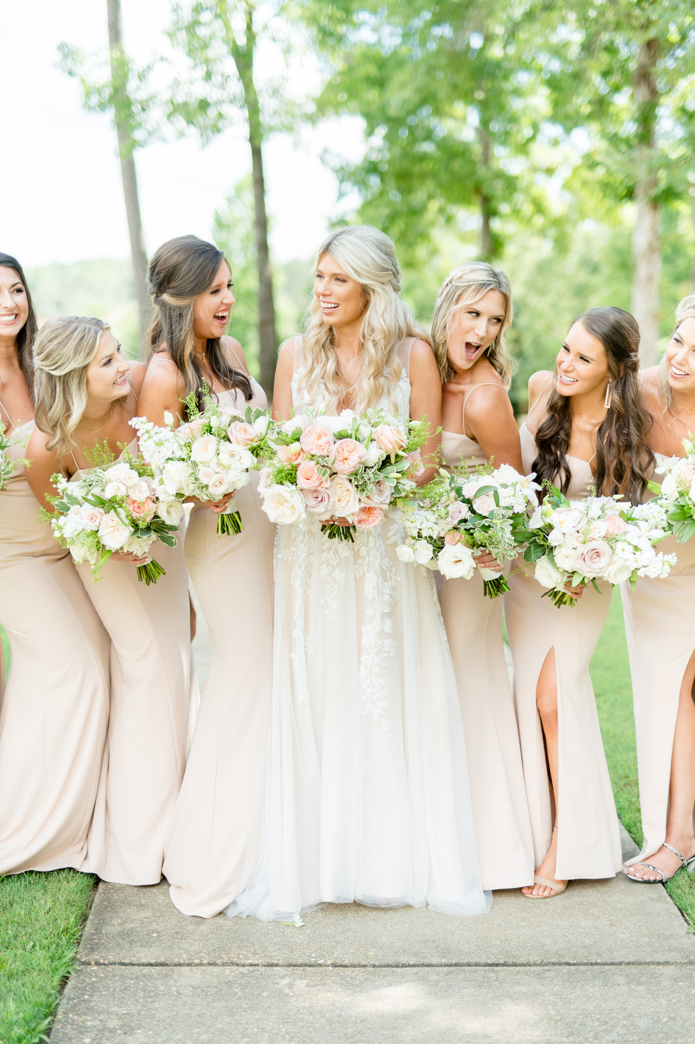 Bride laughs with bridal party.