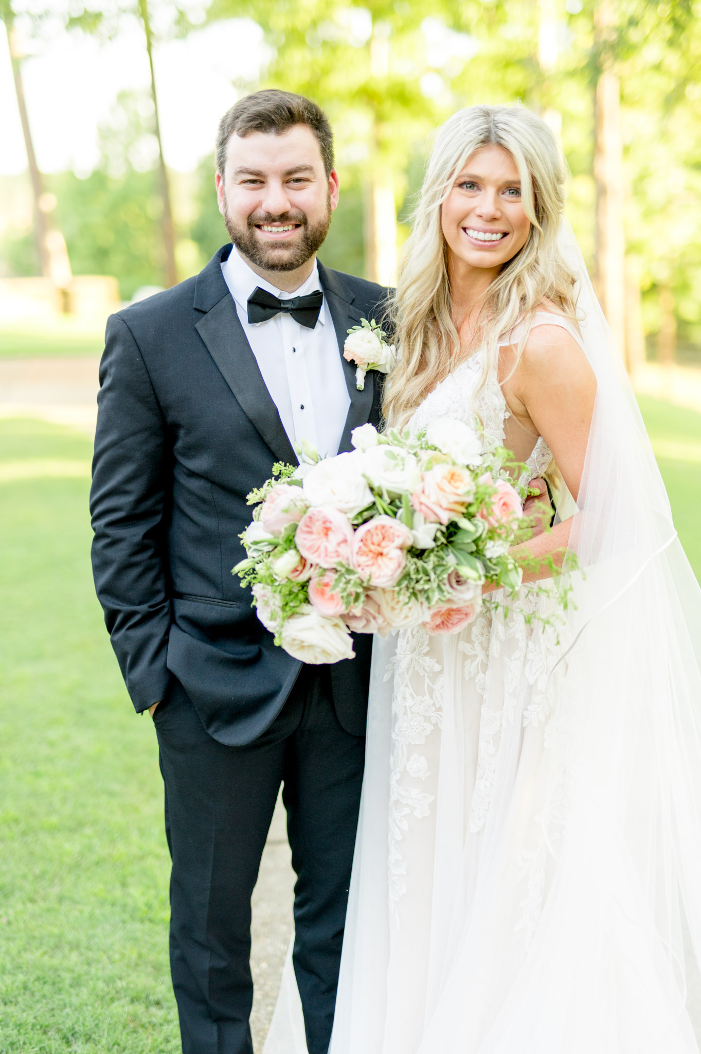 Wedding couple smiles at camera.