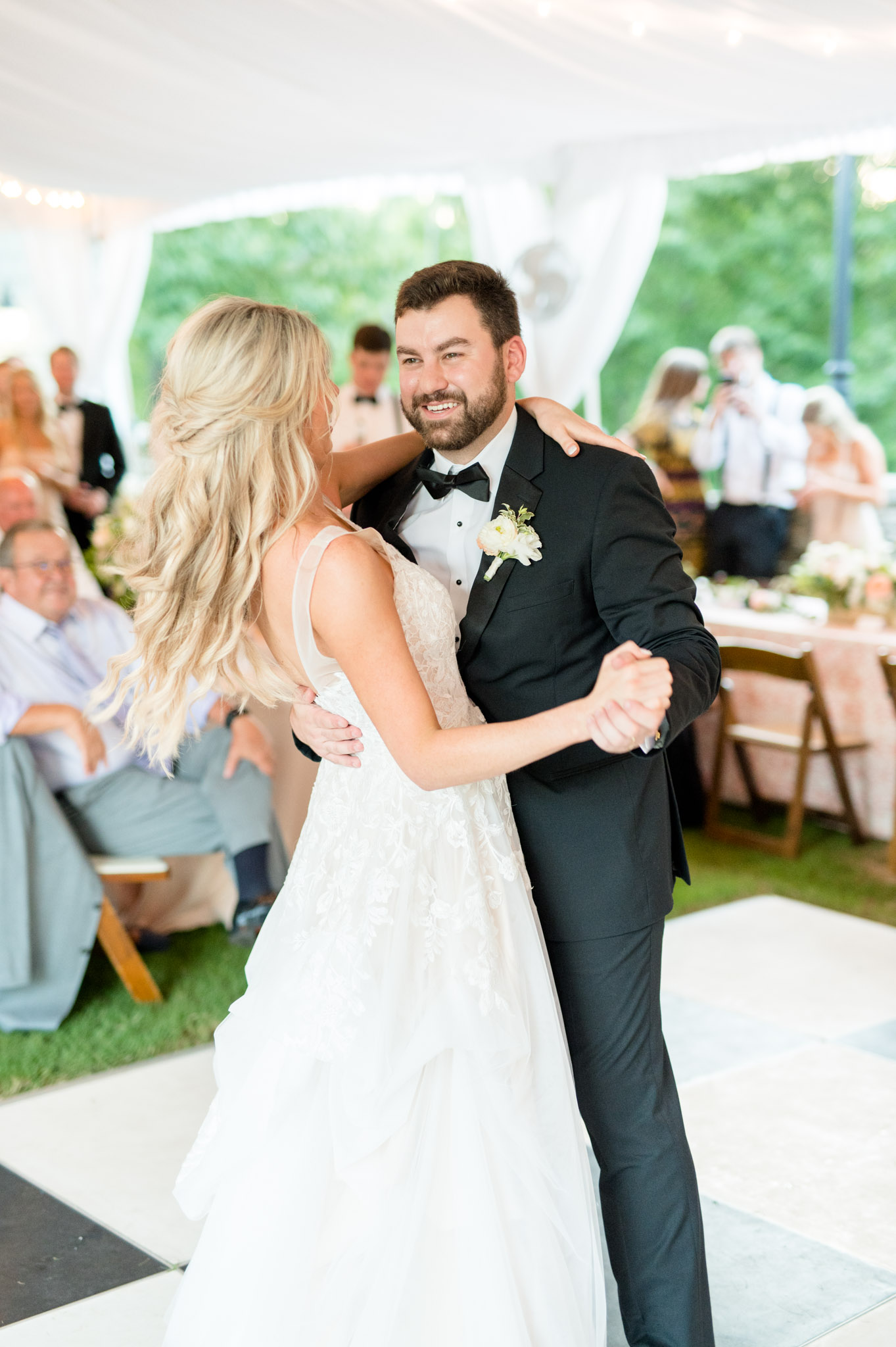 Groom laughs during first dance. 