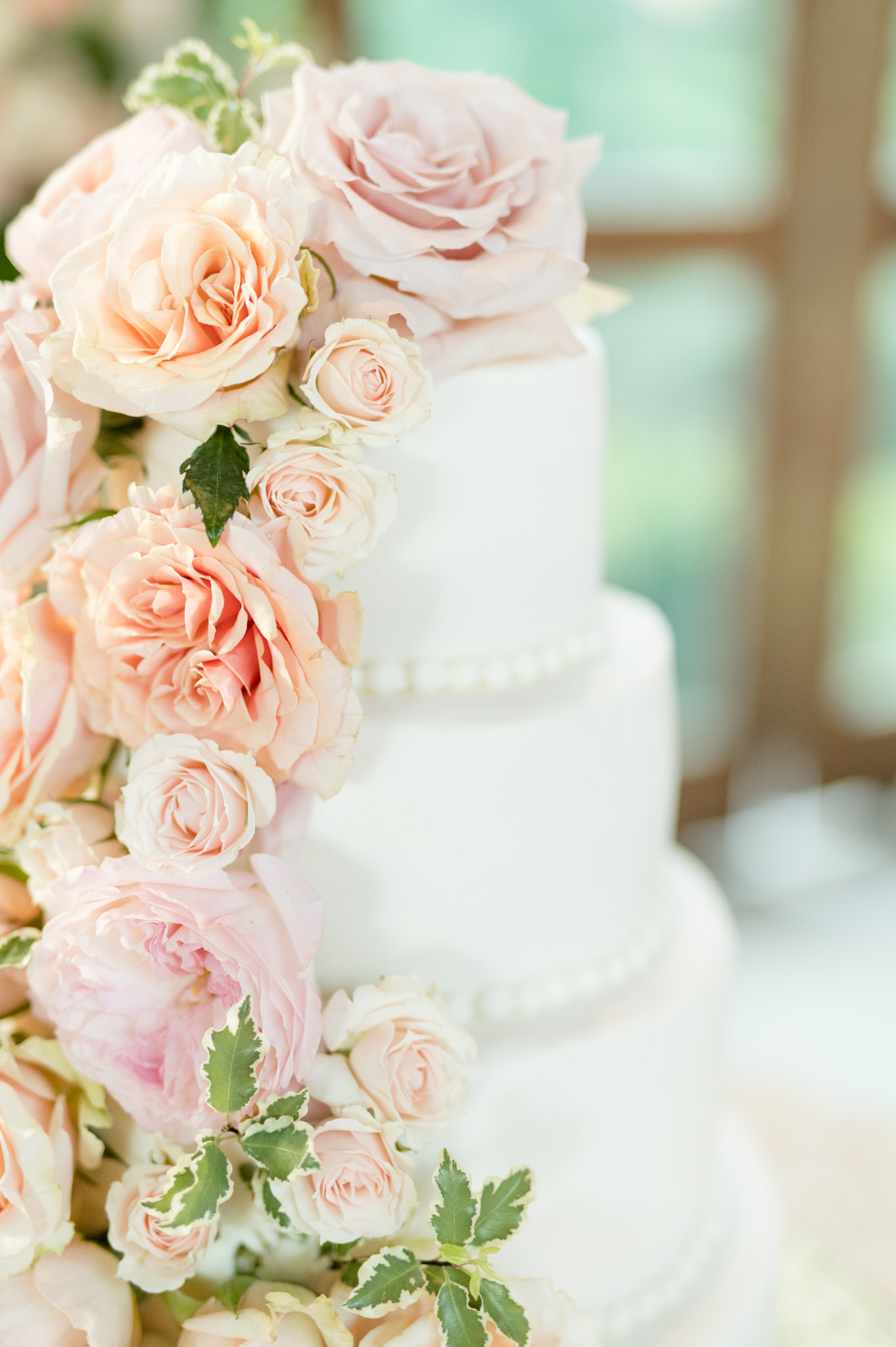 Closeup of flowers on wedding cake.