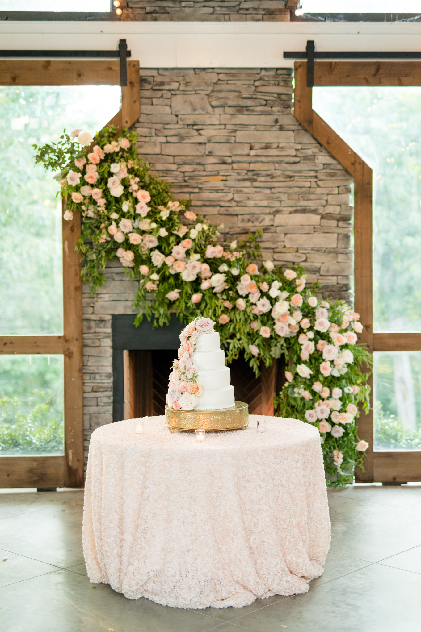 Wedding cake sits on cake table.