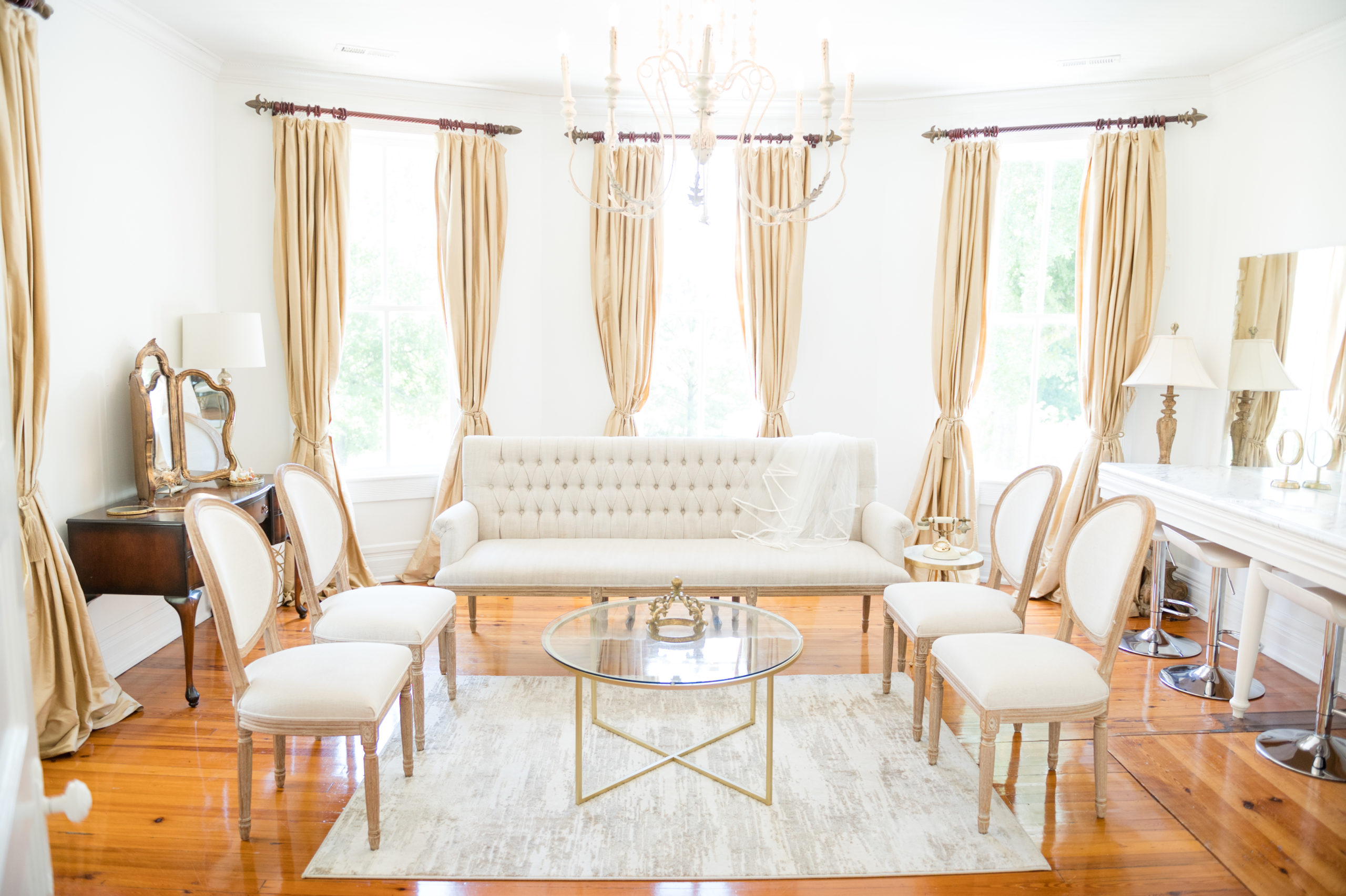 Bridal getting ready room has seating space and vanities.