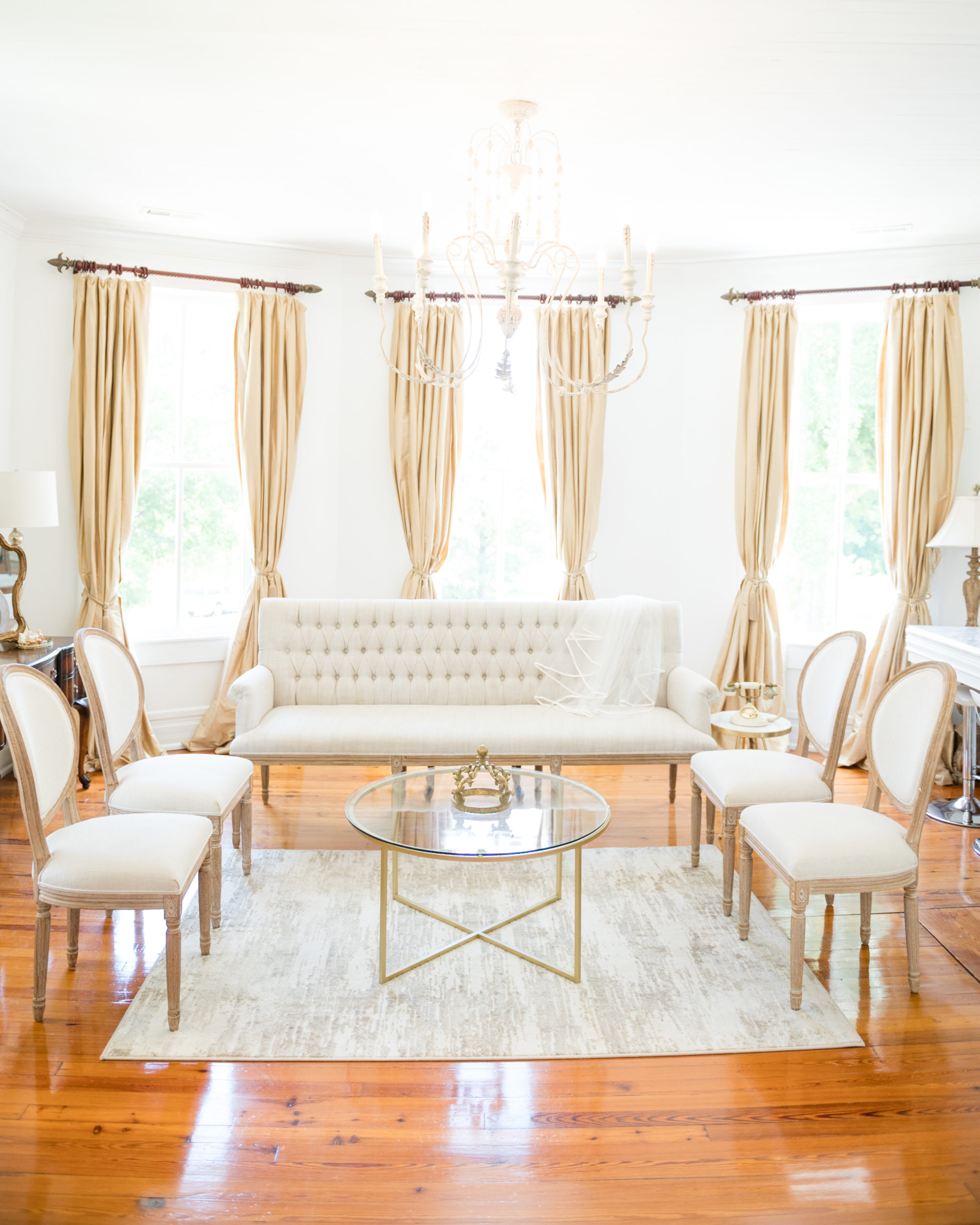 Cream couch and chairs sit in bridal getting ready room.