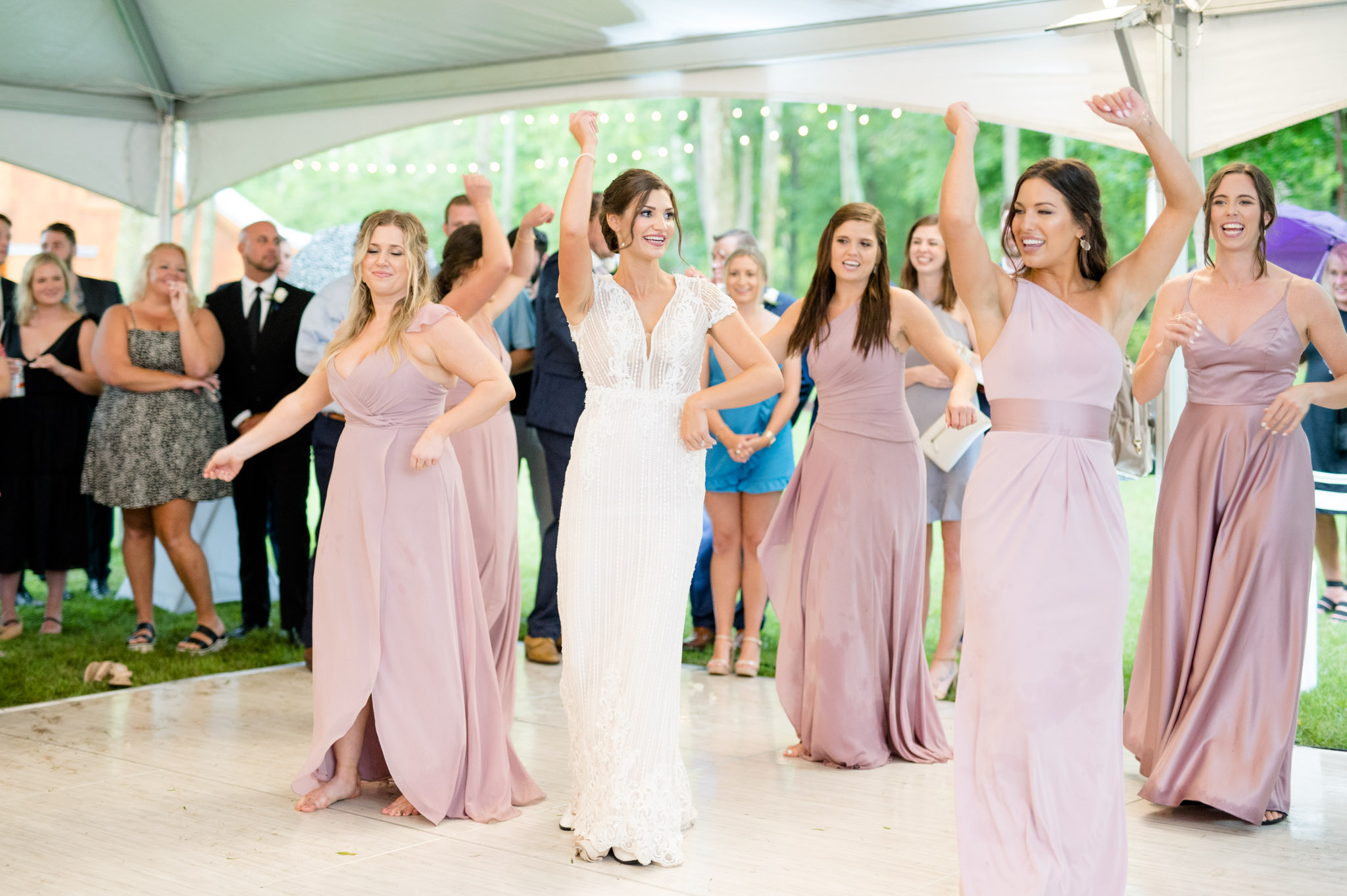 Bride and bridesmaid's dance together.