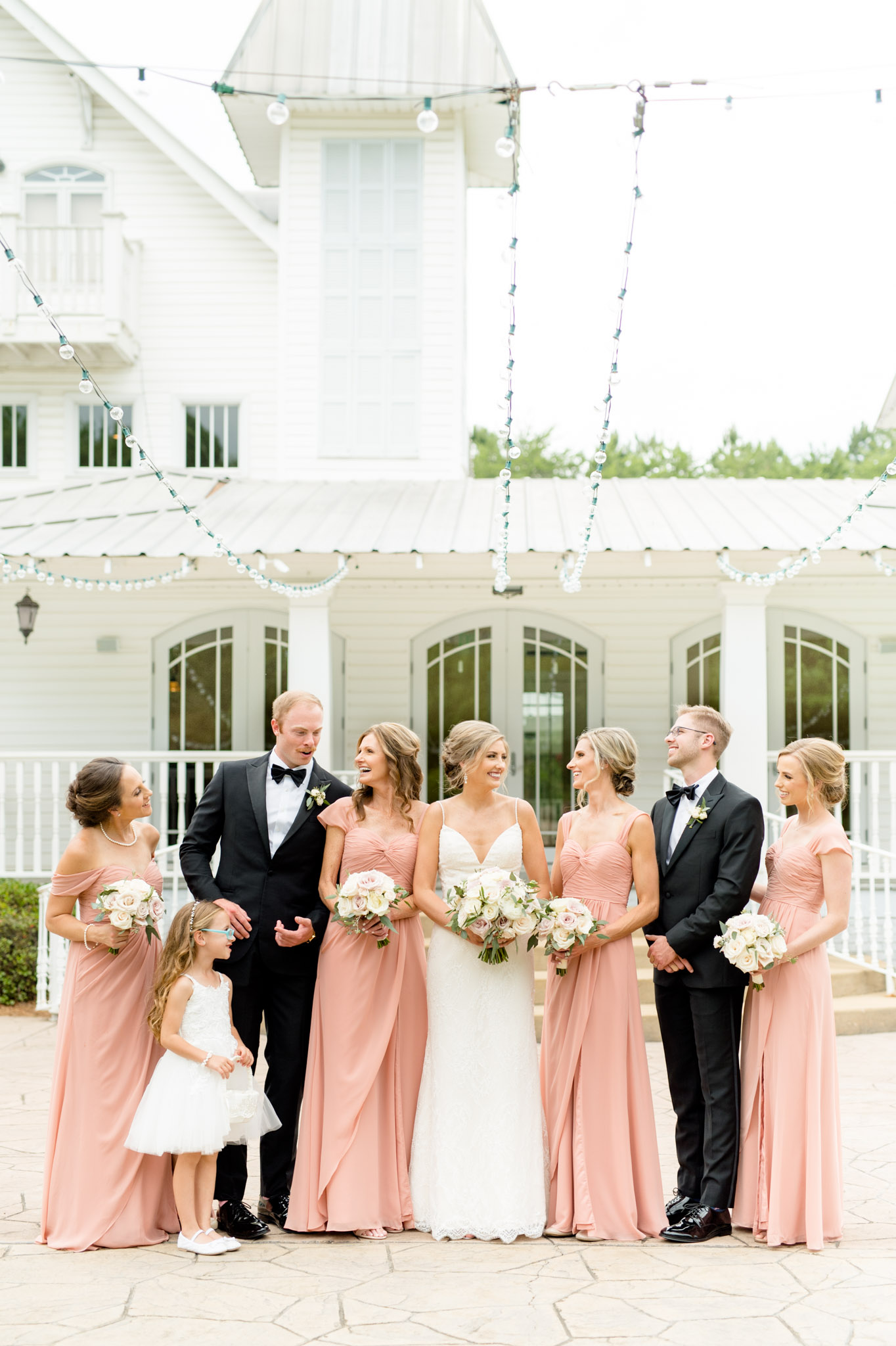 Bridal party laughs together.