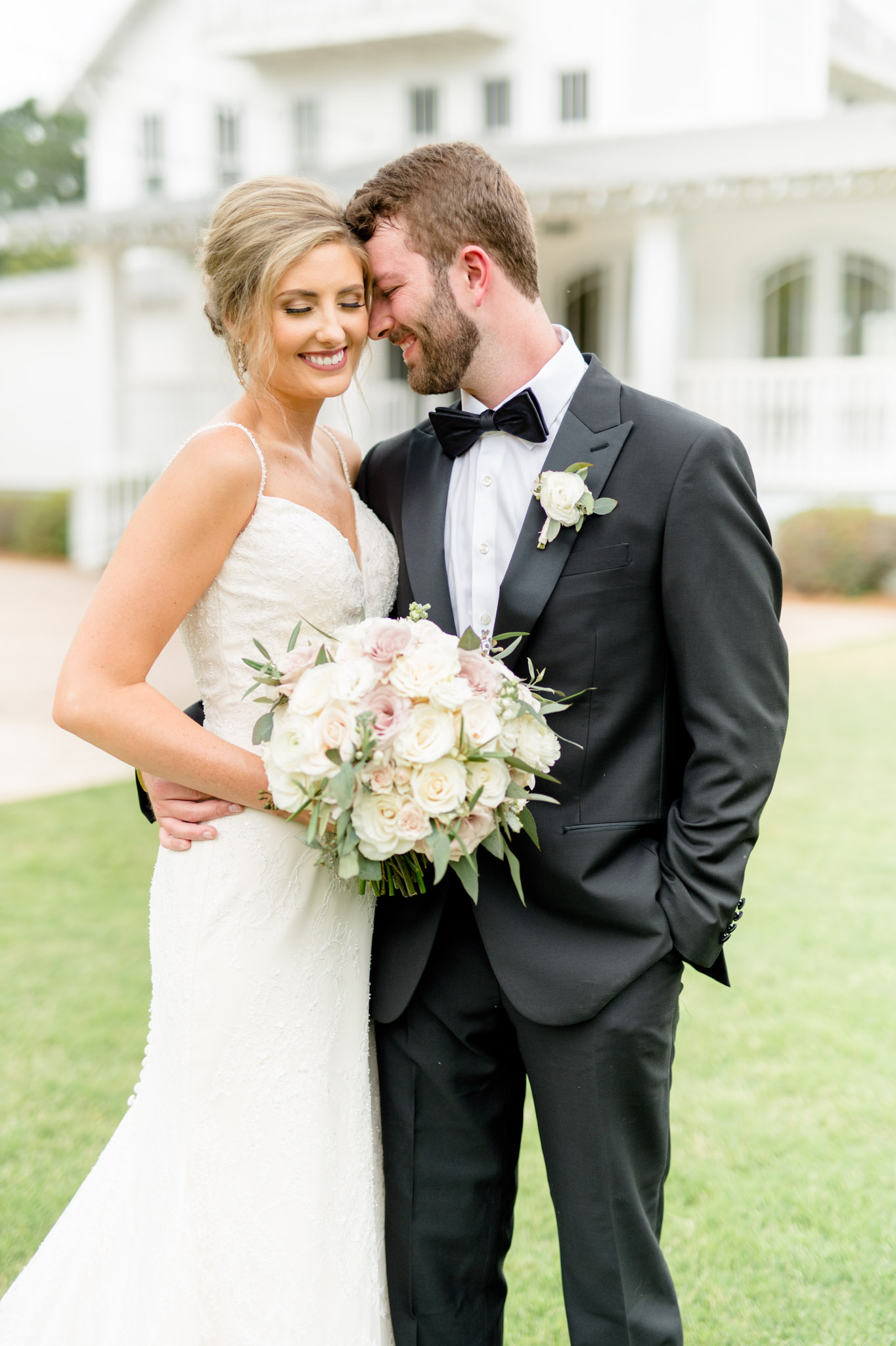 Bride and groom snuggle together.