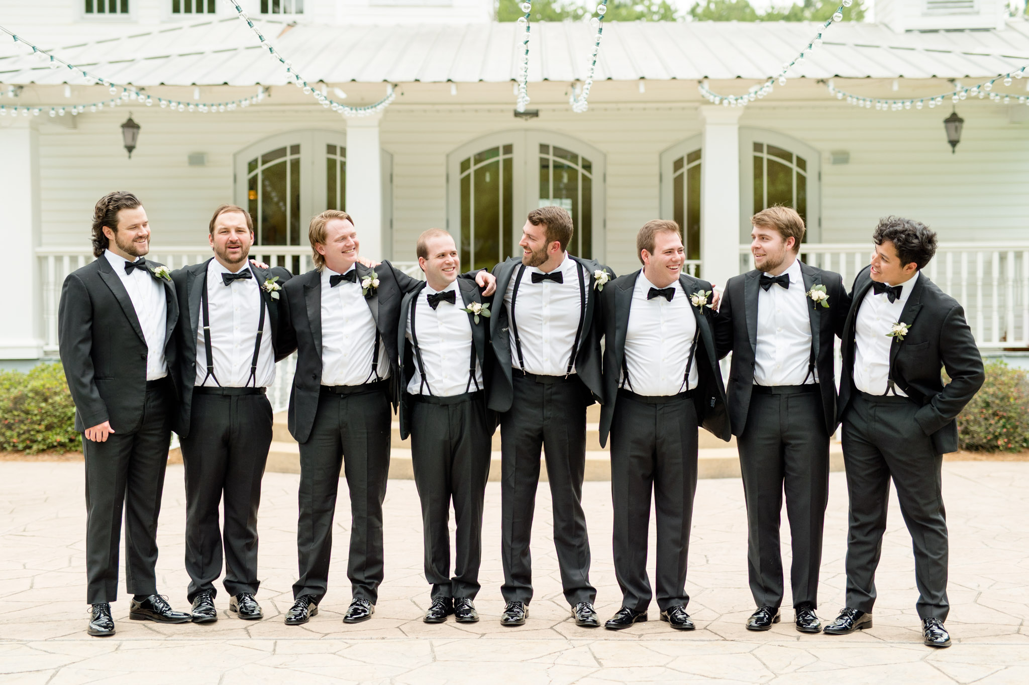 Groom and groomsmen laugh together