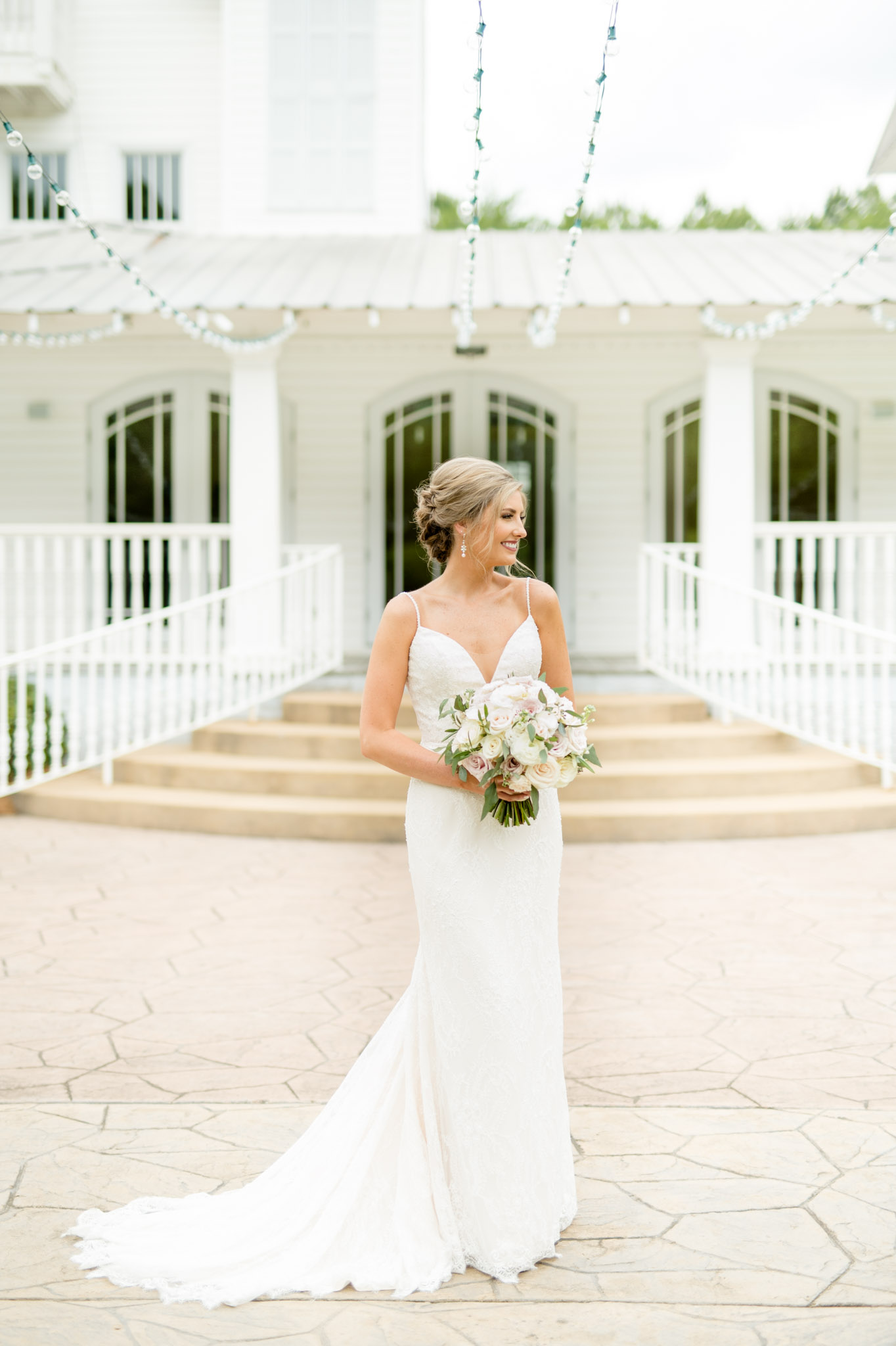 Bride looks over shoulder and smiles at The Sonnet House.