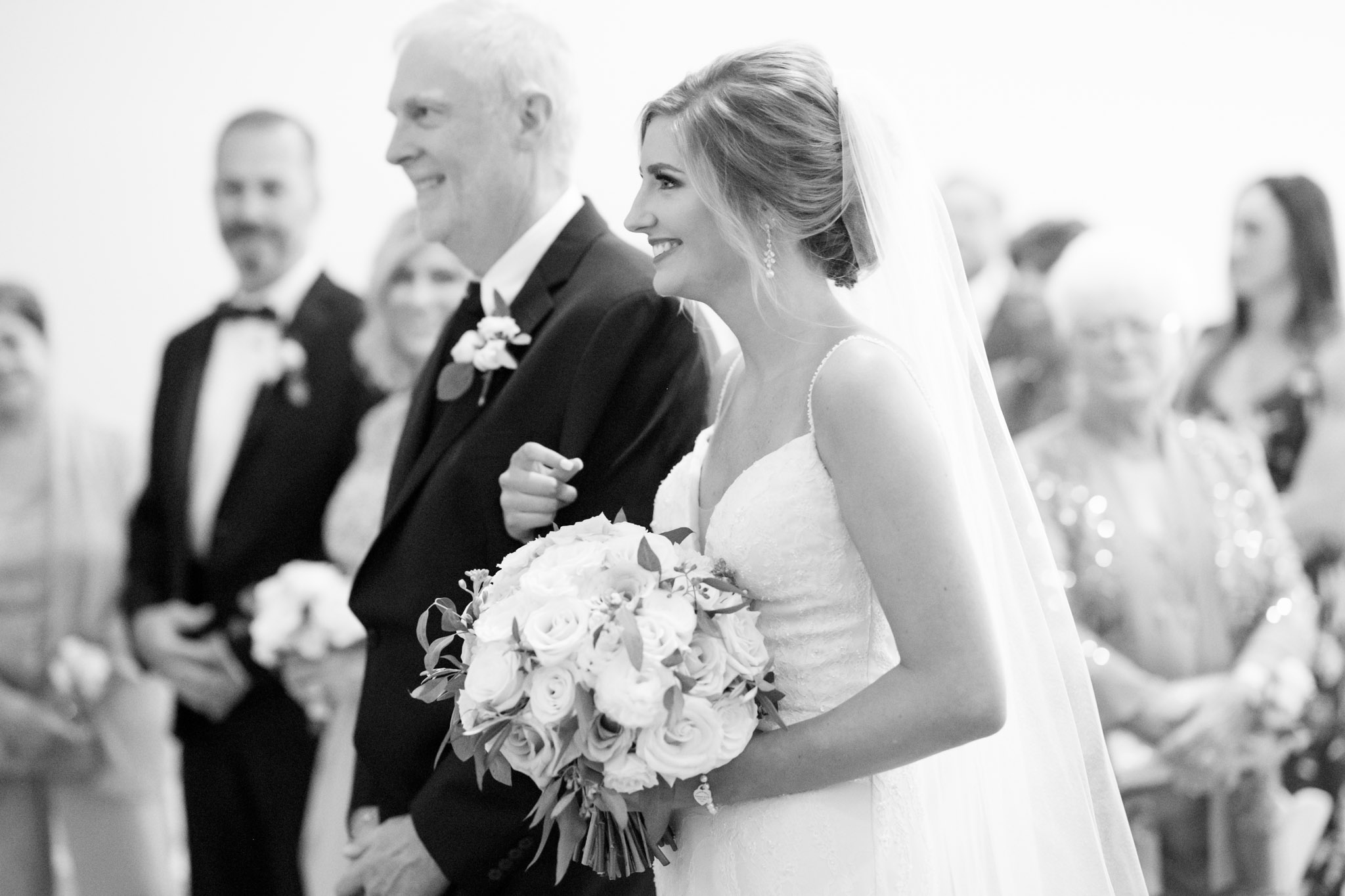 Bride walks down aisle with father.