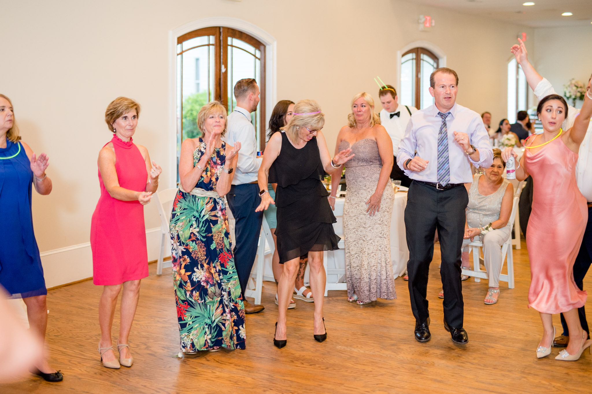 Wedding guests dance at reception.