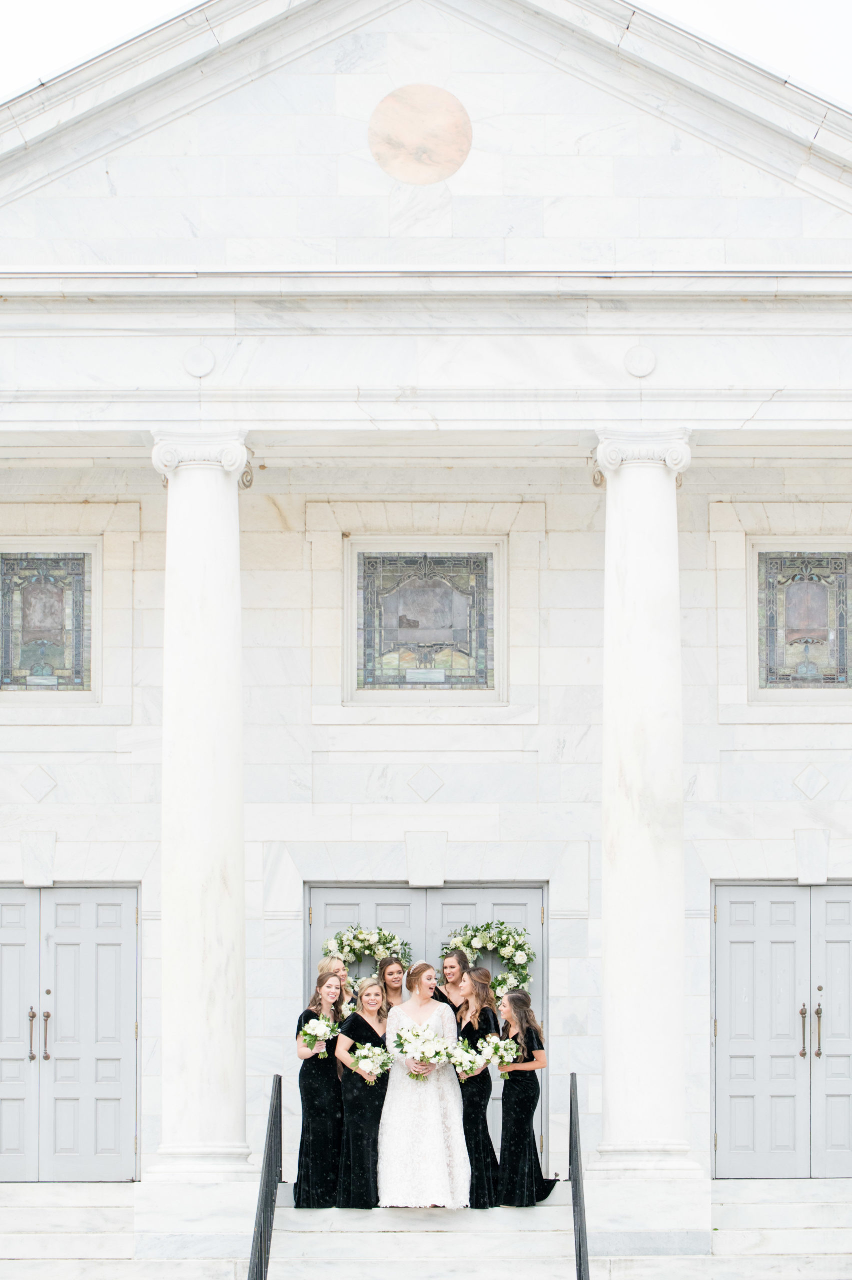 Bride and bridesmaids laugh together.