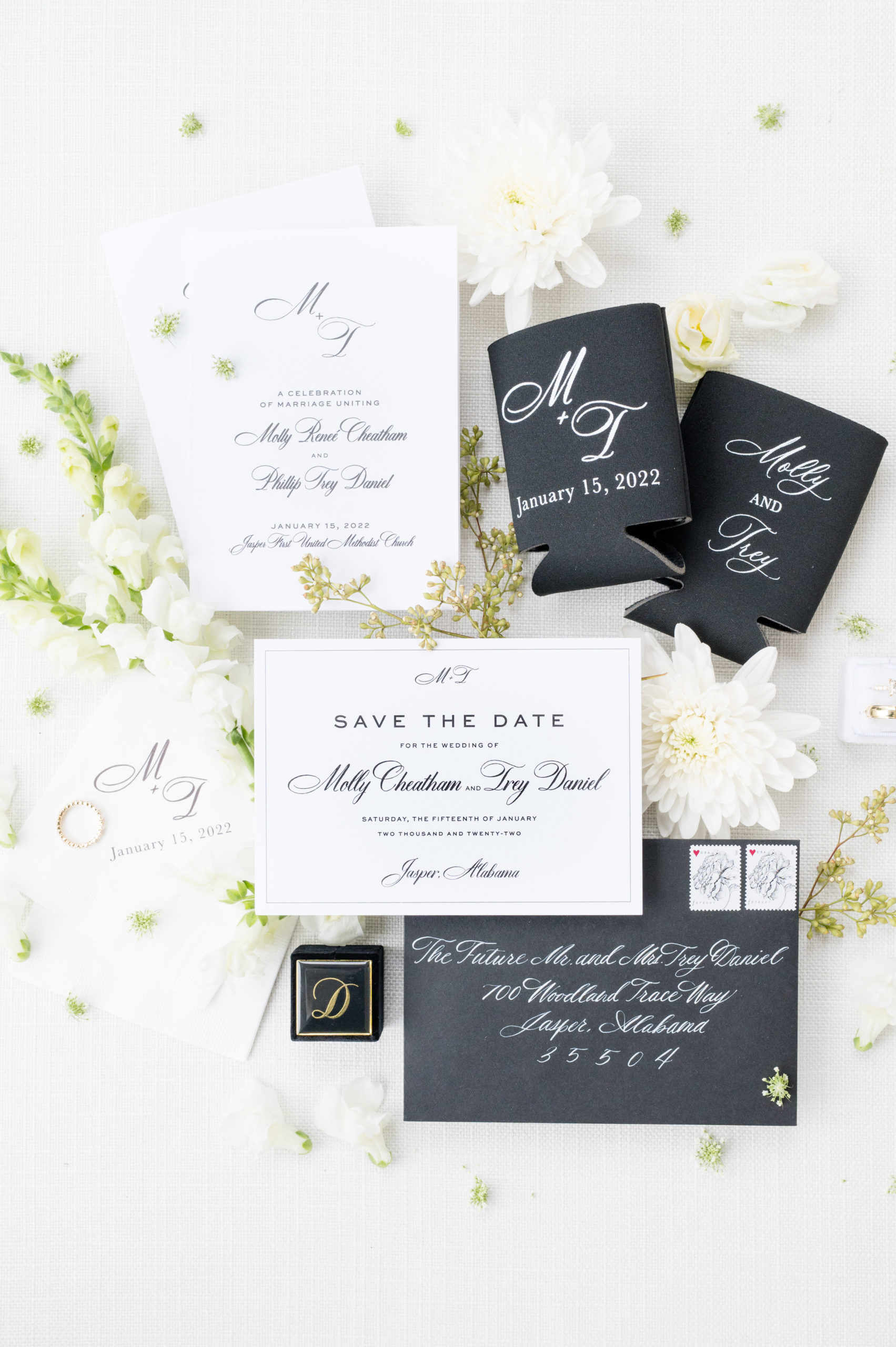 Save the date and reception details sits with flowers.