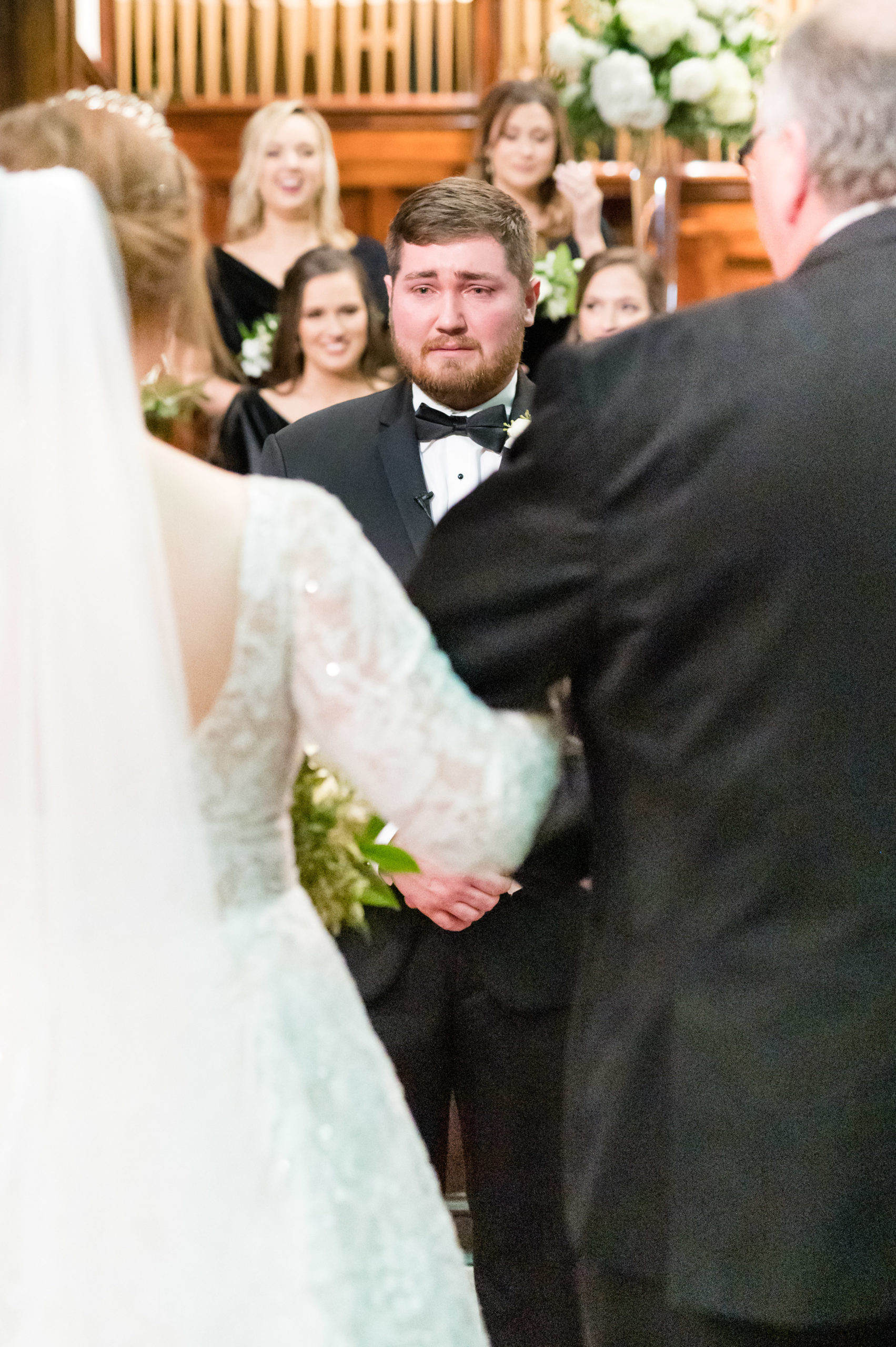 Groom cries at bride walks down aisle.