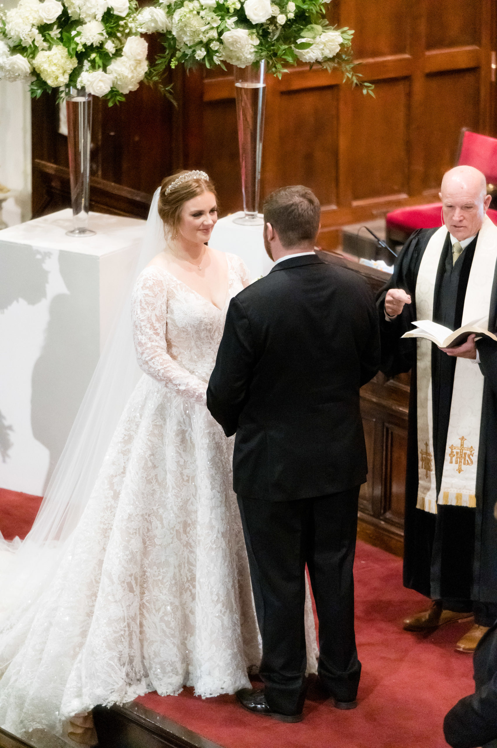 Bride smiles at groom during wedding ceremony.