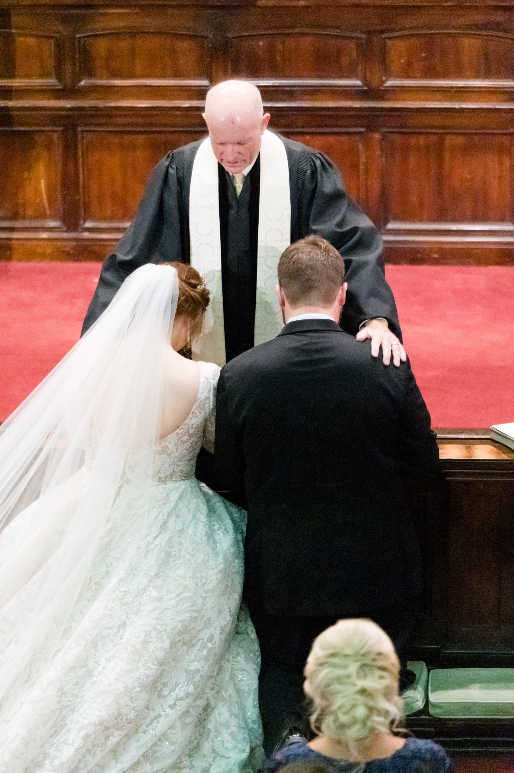 Minister prays over couple at ceremony.