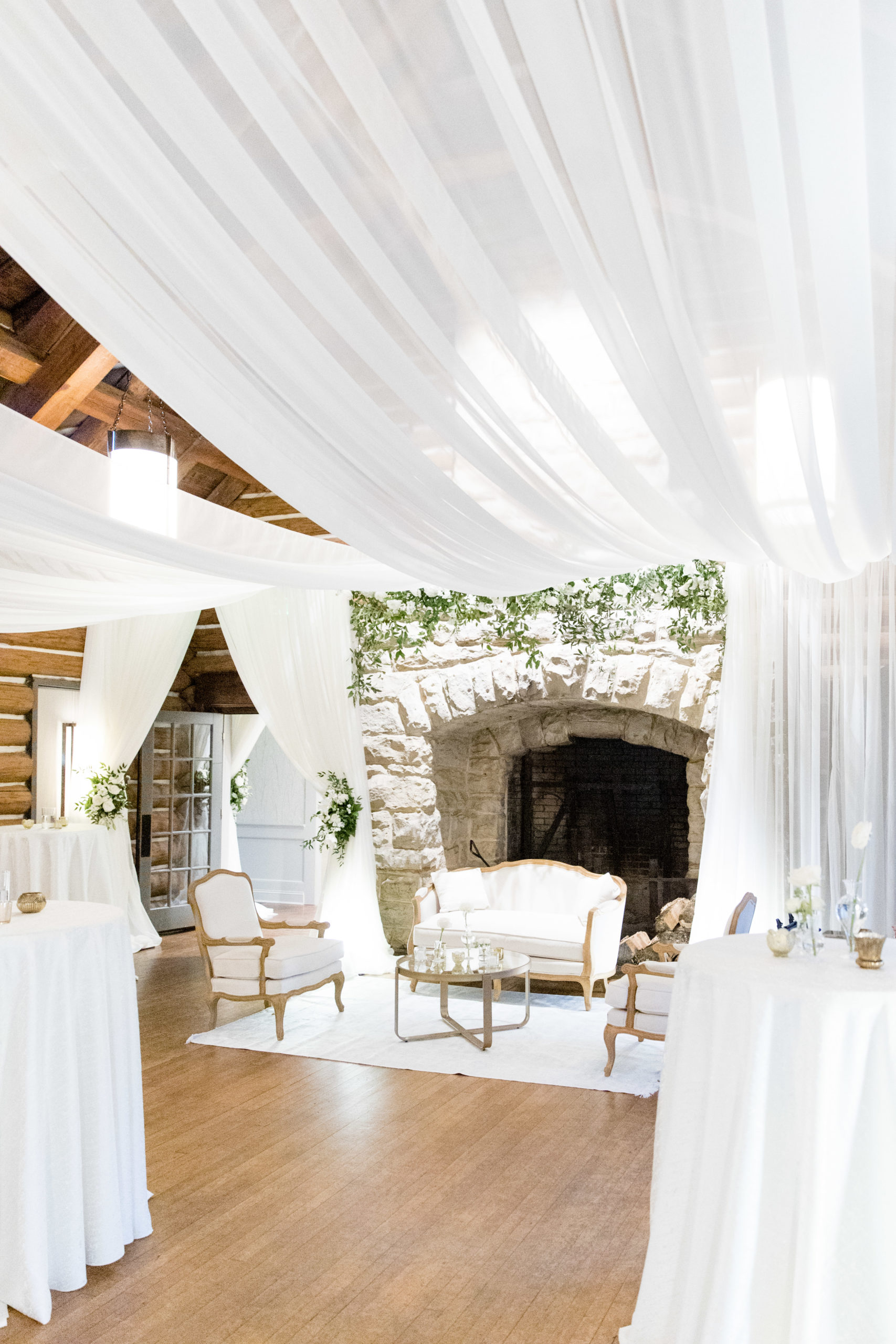 White draping and lounge area at wedding reception.