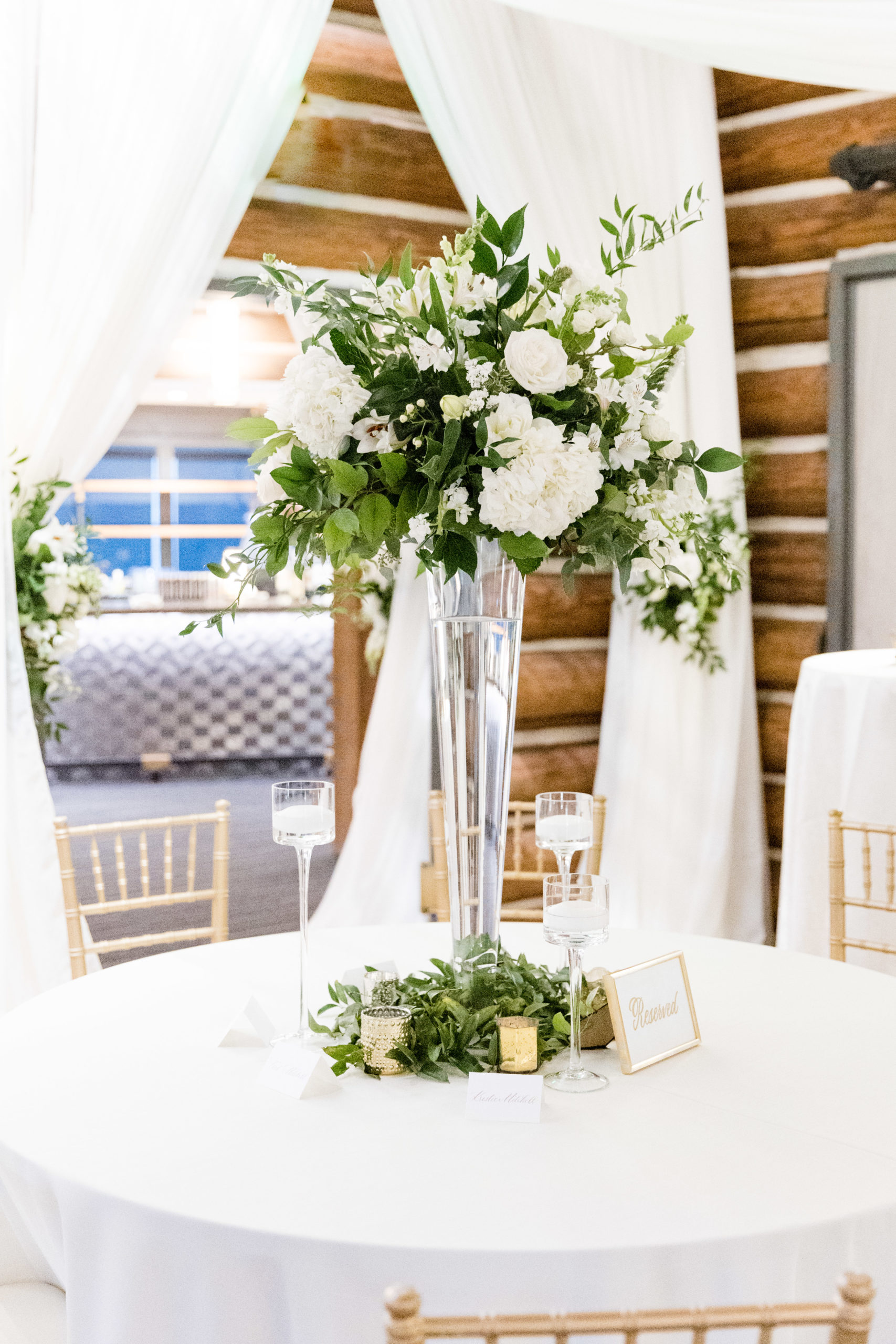White floral centerpieces at wedding reception.