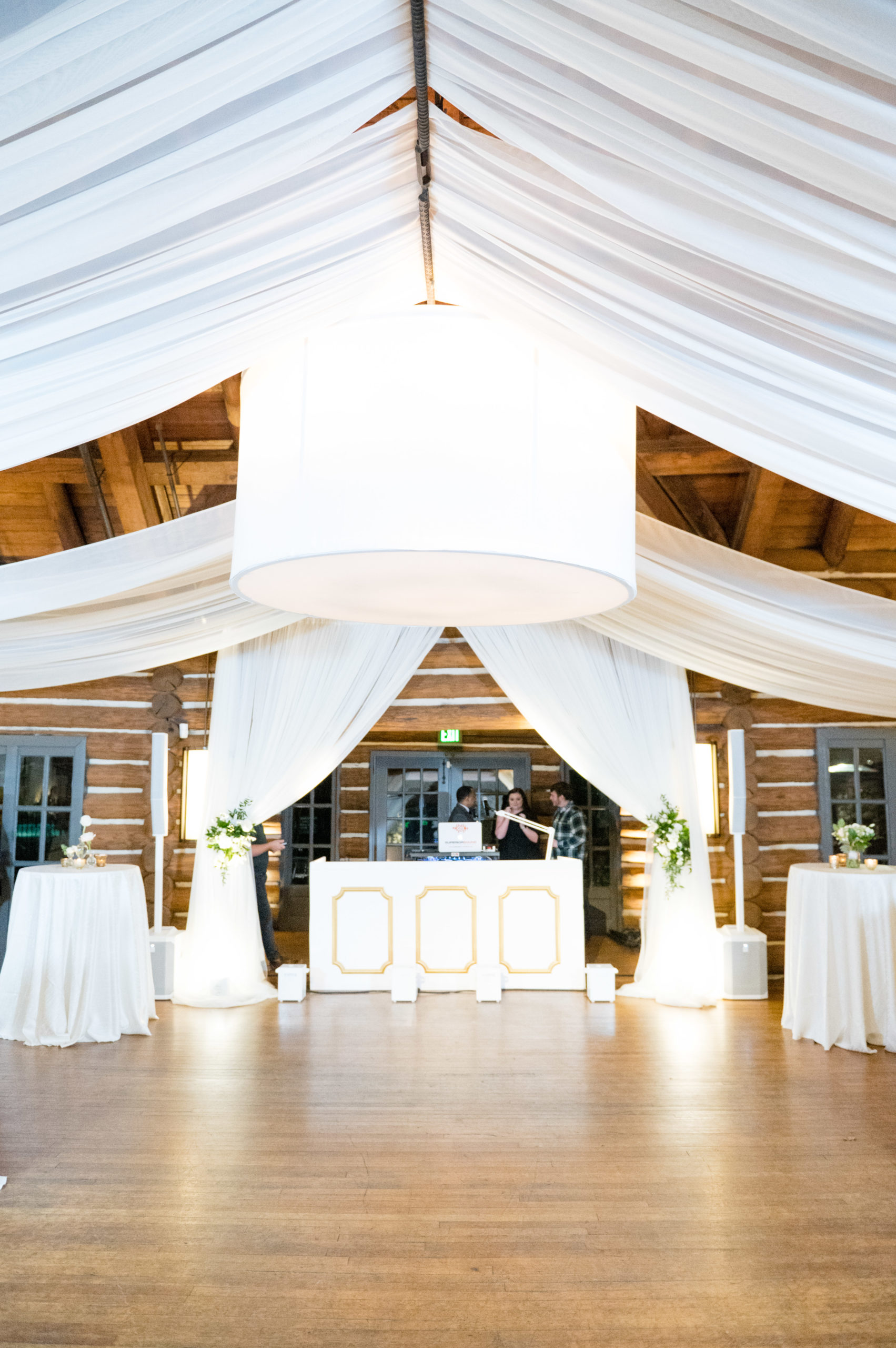 Wedding reception dancefloor with white draping.