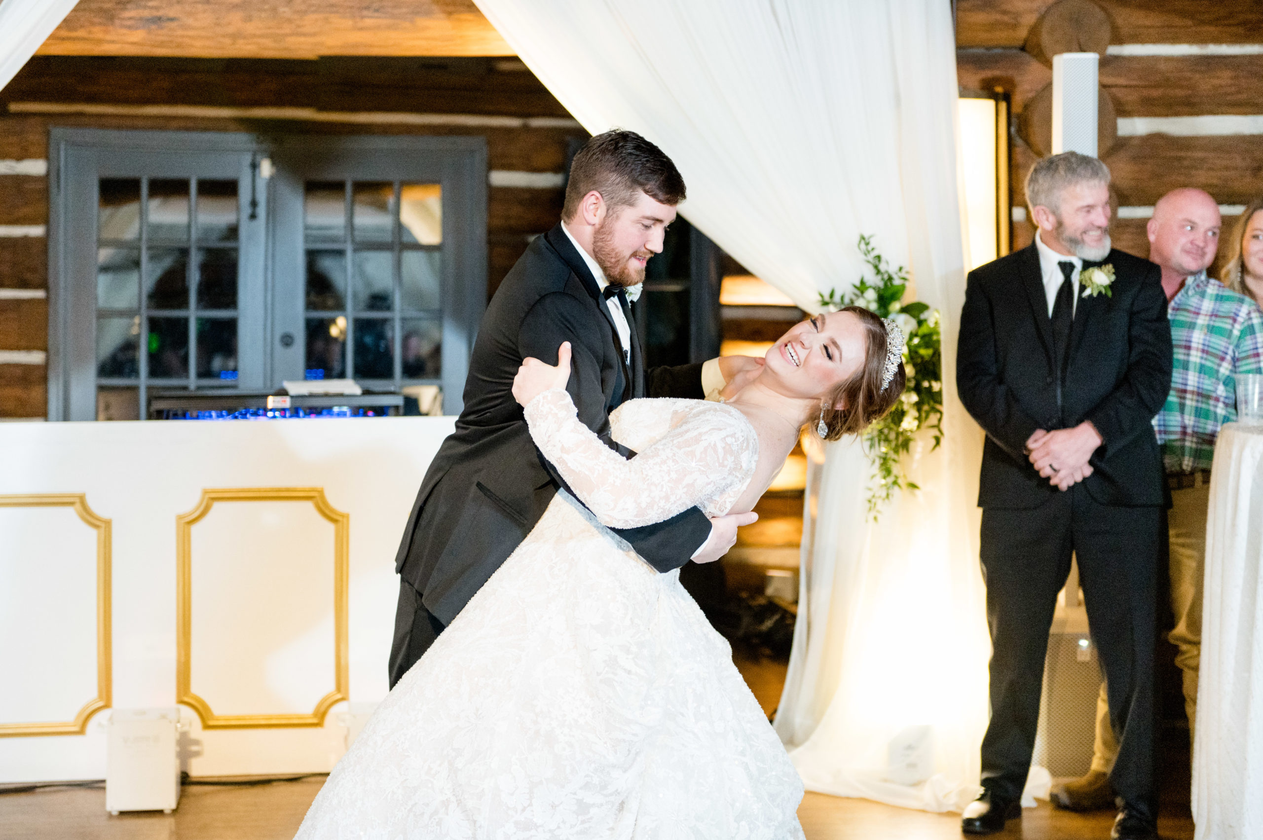 Groom dips bride at reception.