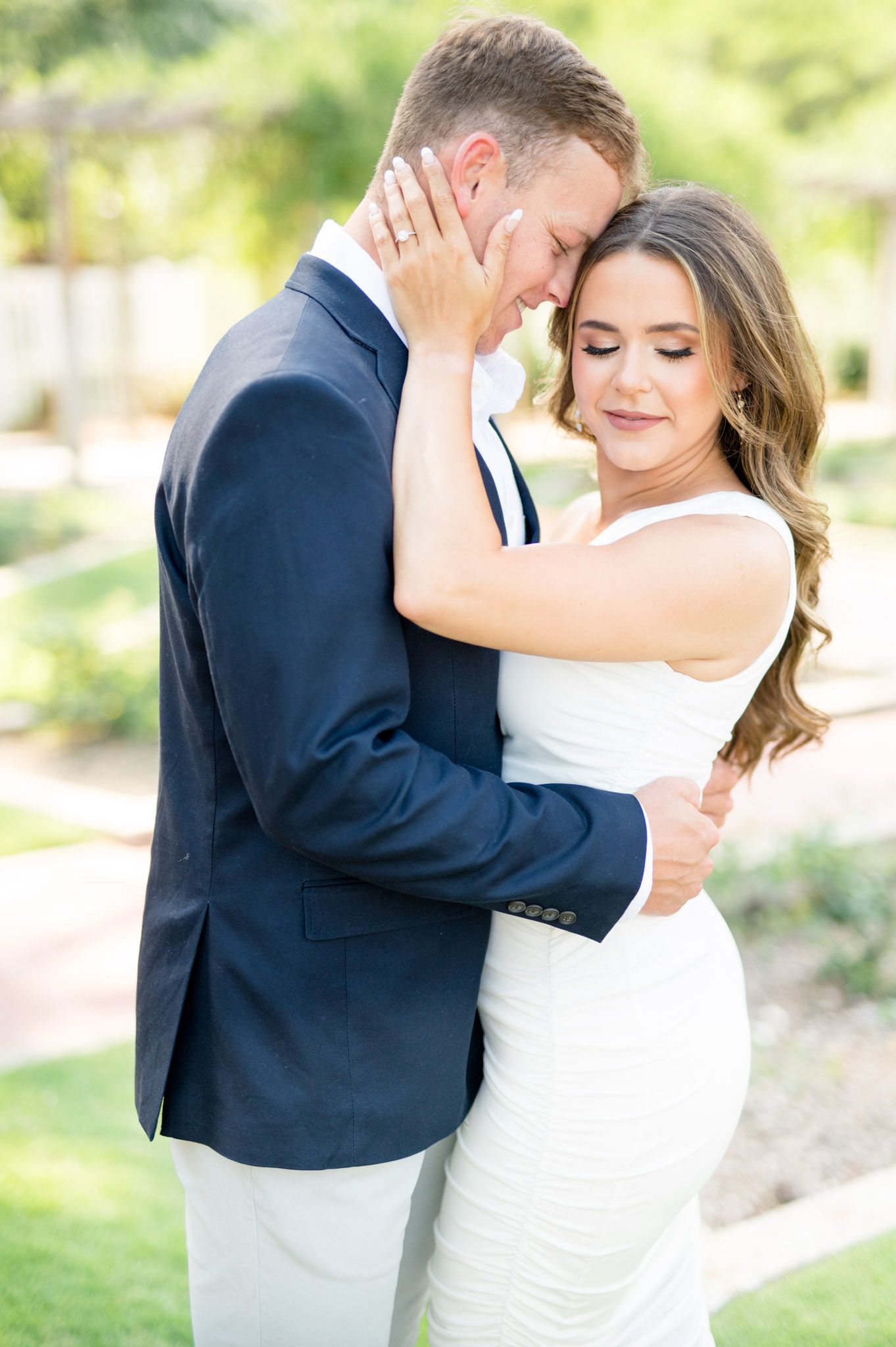 Groom-to-be snuggles in to fiance.