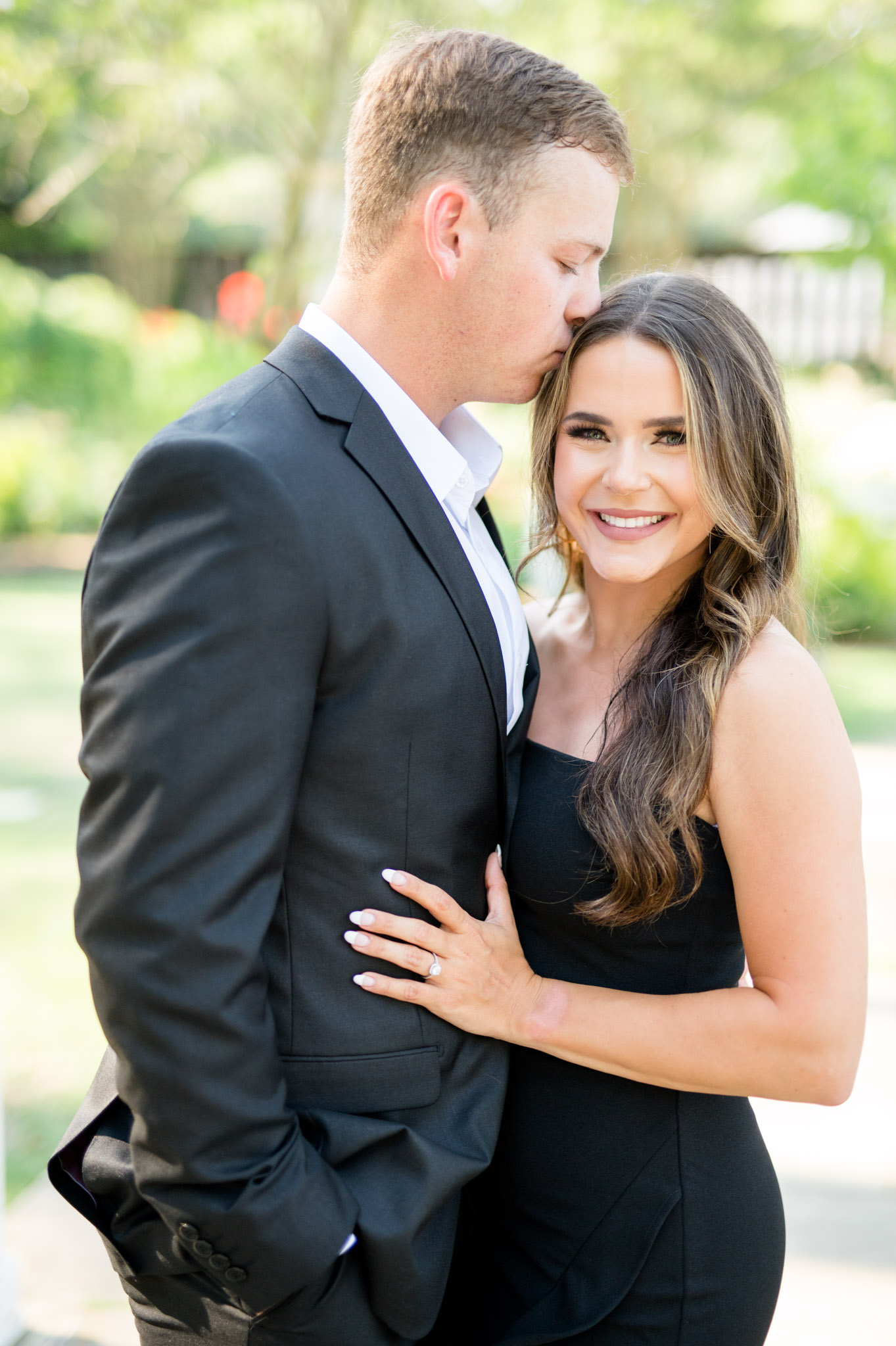 Groom kisses fiances temple.