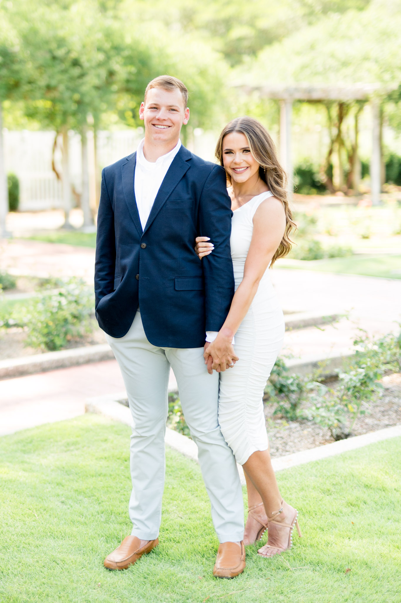 Couple holds hands and smiles.