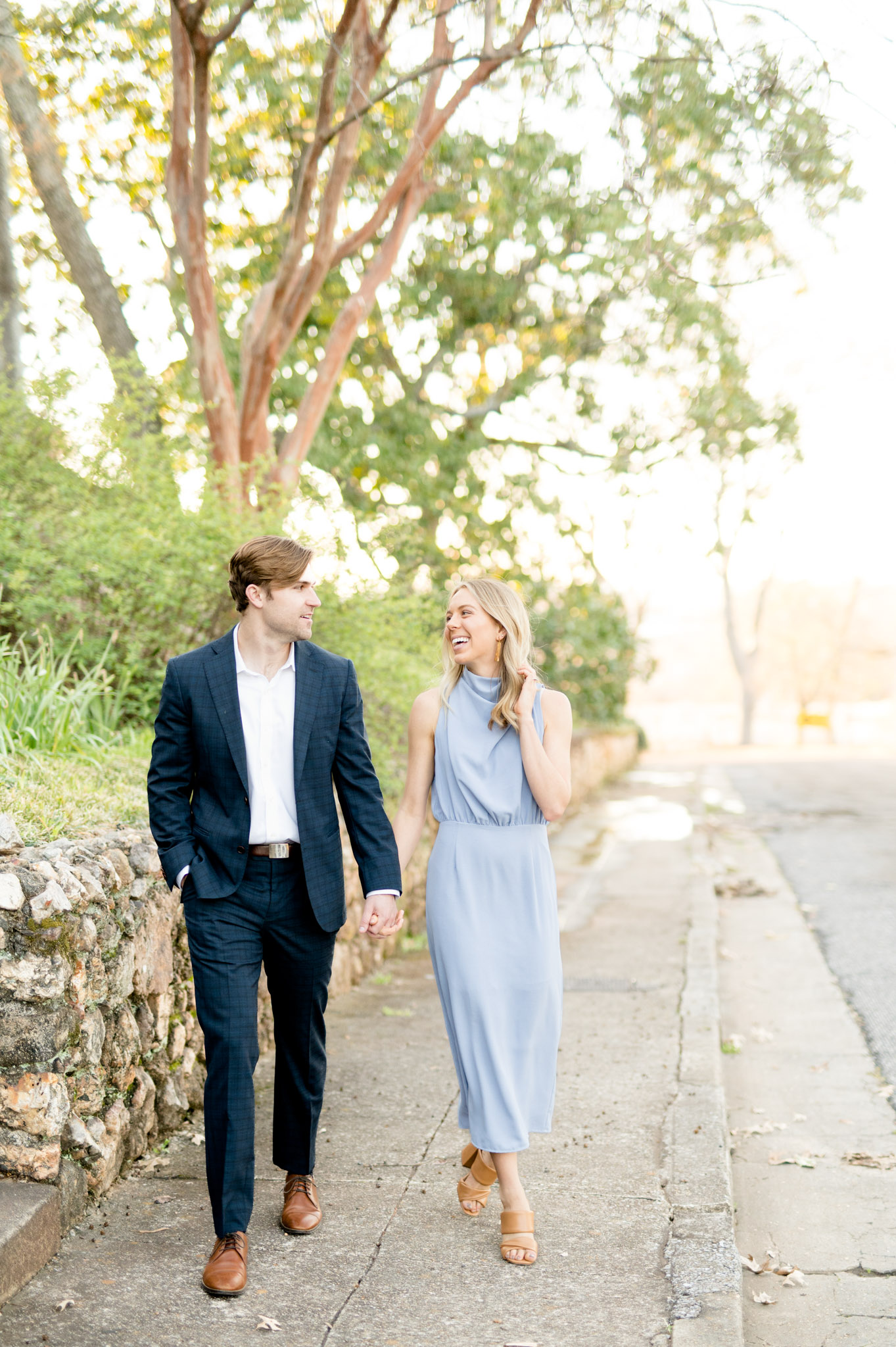 Couple walks on historic sidewalk.