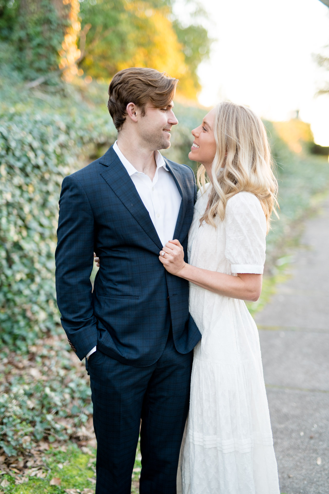 Couple looks at each other while standing close.