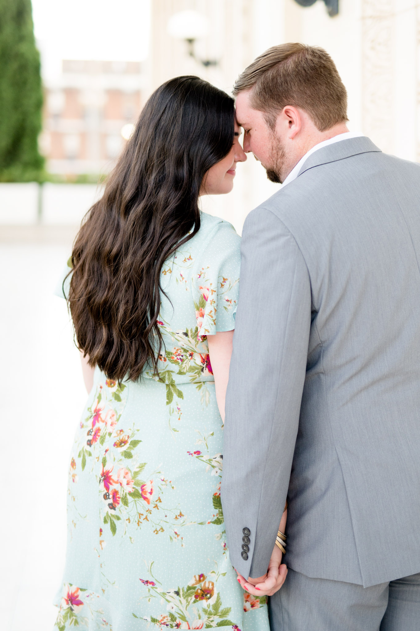 Couple snuggles forehead together.