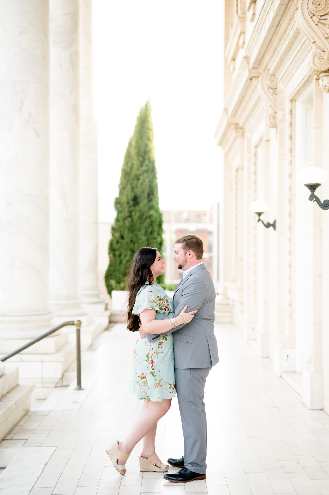 Couple embraces and smiles at each other.