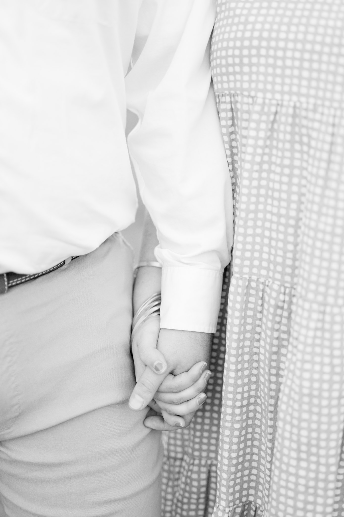 Closeup of couple holding hands.