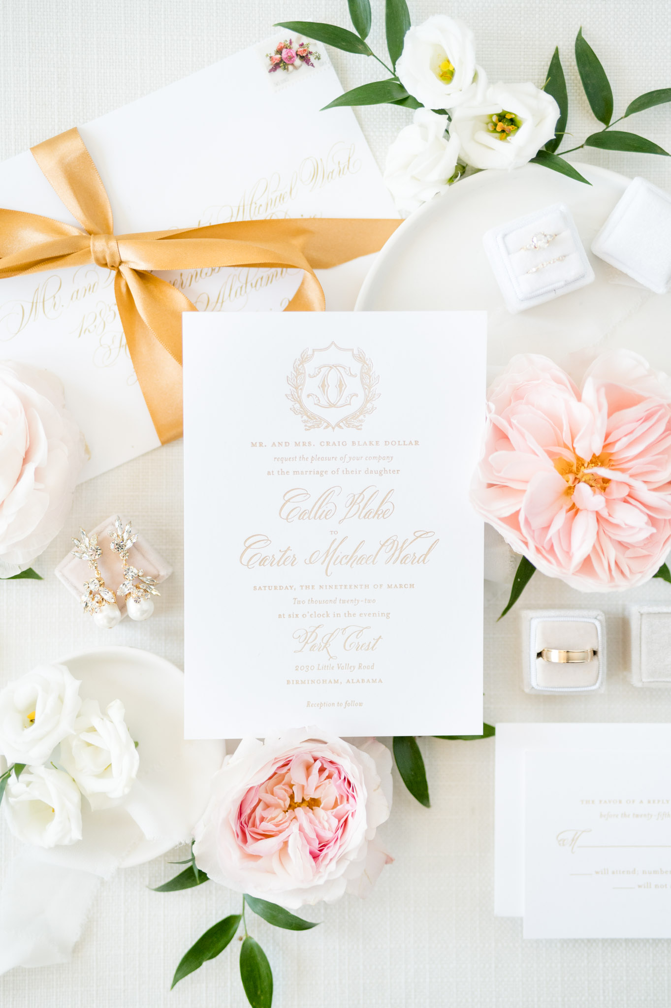 Wedding invitation is surrounded by flowers.