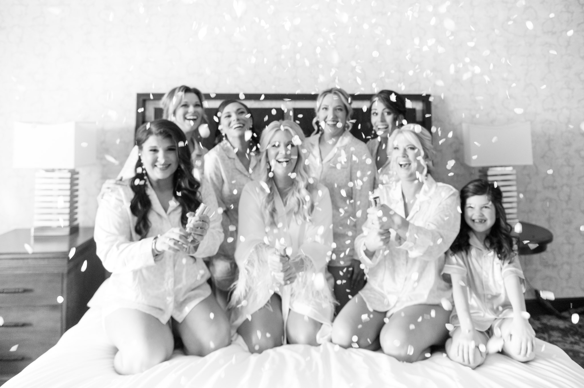 Bride and bridesmaids pop confetti.