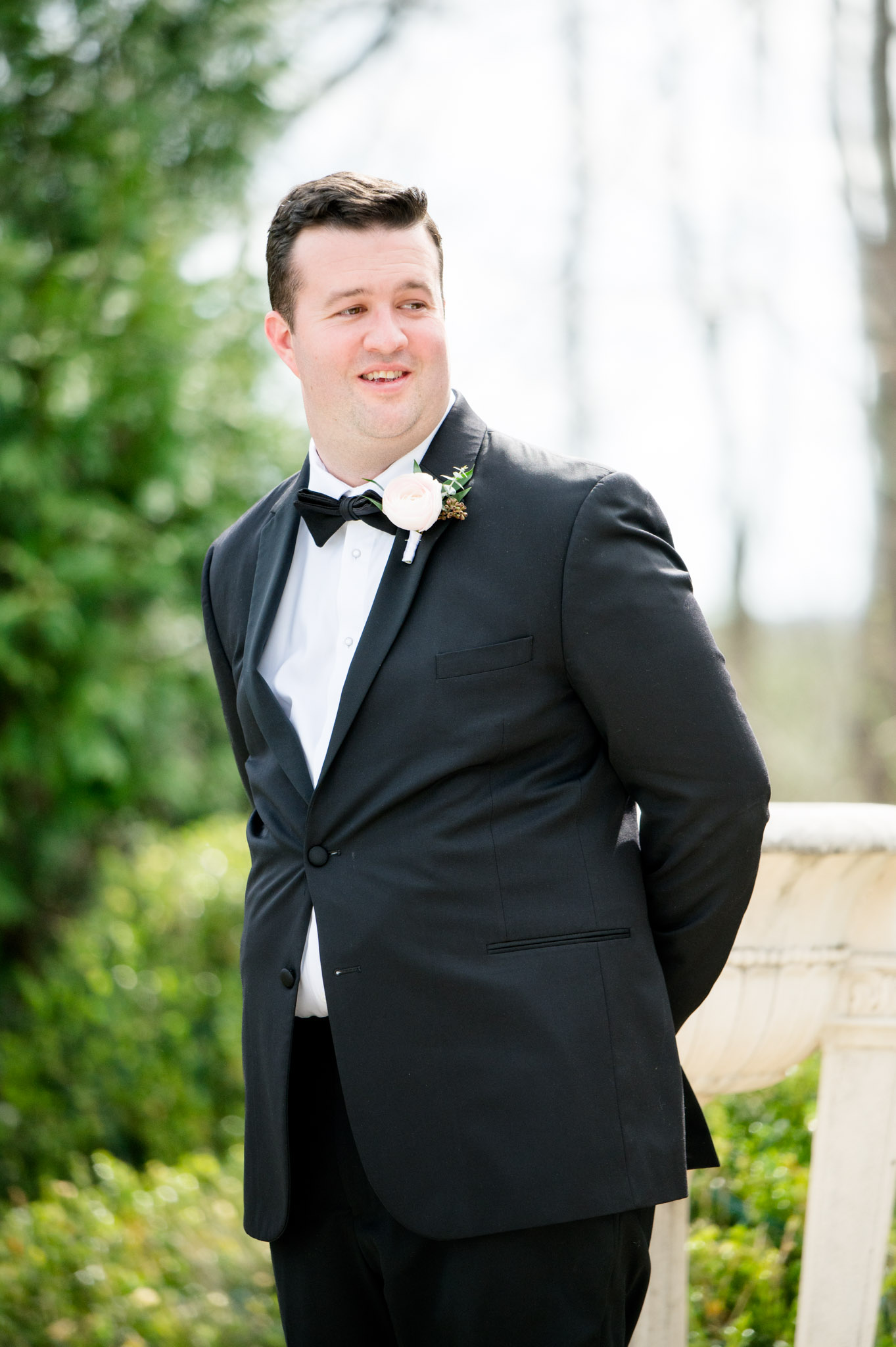 Groom smiles during first look.