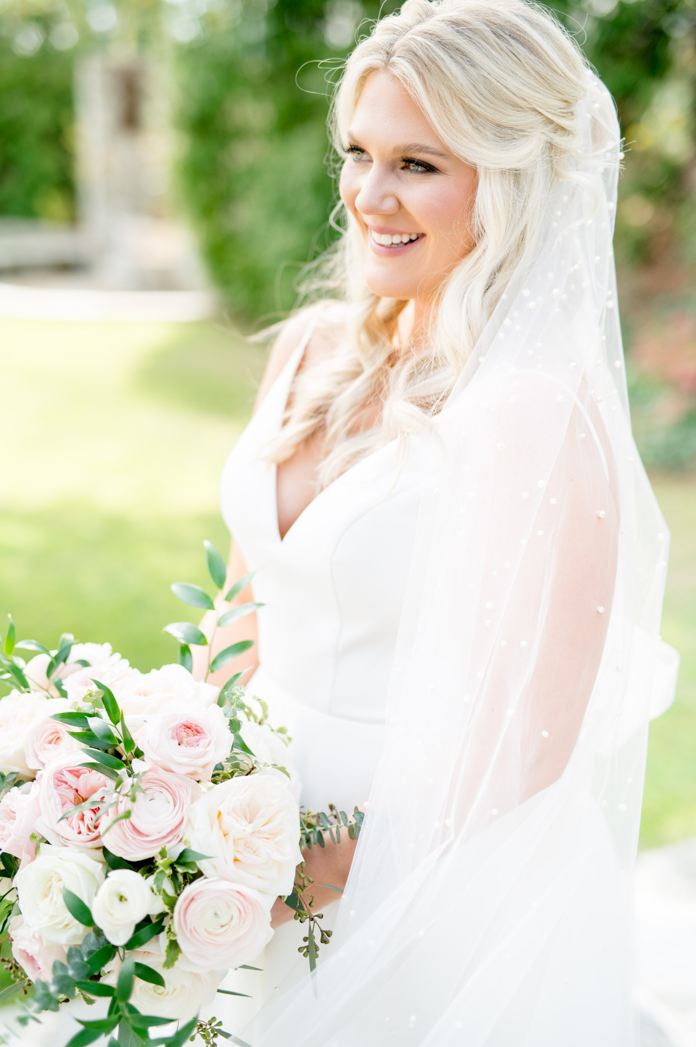 Bride looks over shoulder and laughs.