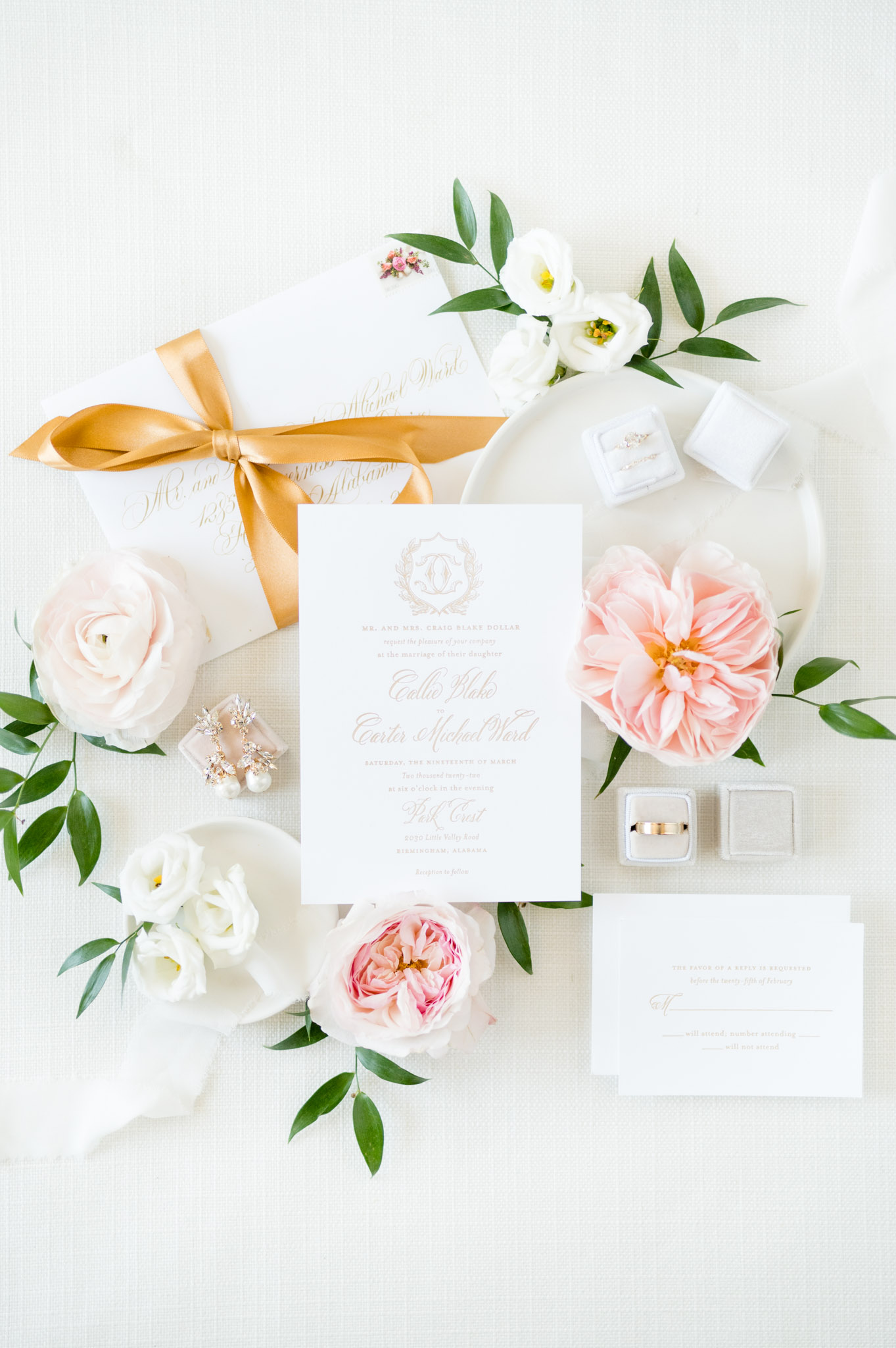White wedding invitation and pink flowers.